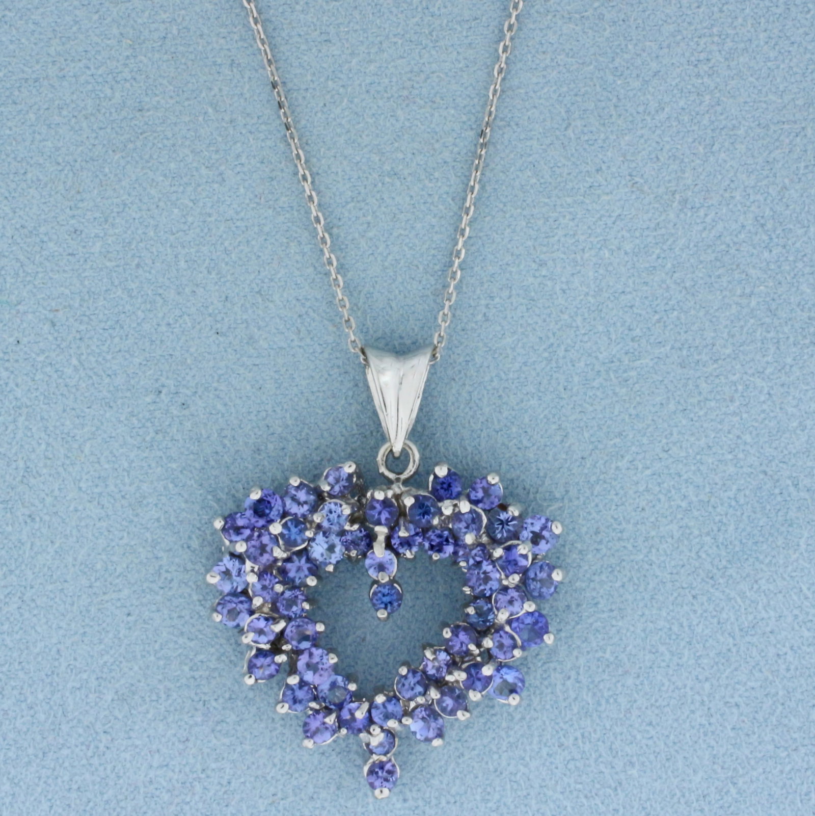 Tanzanite Heart Necklace in 14k White Gold: In 14k White Gold. Contains fifty-one AA quality natural Tanzanite gemstones, approximately 3ct TW, with vivid color and excellent clarity. Pendant is 1.5 inch long including bale by 1 1/8 inch wide .