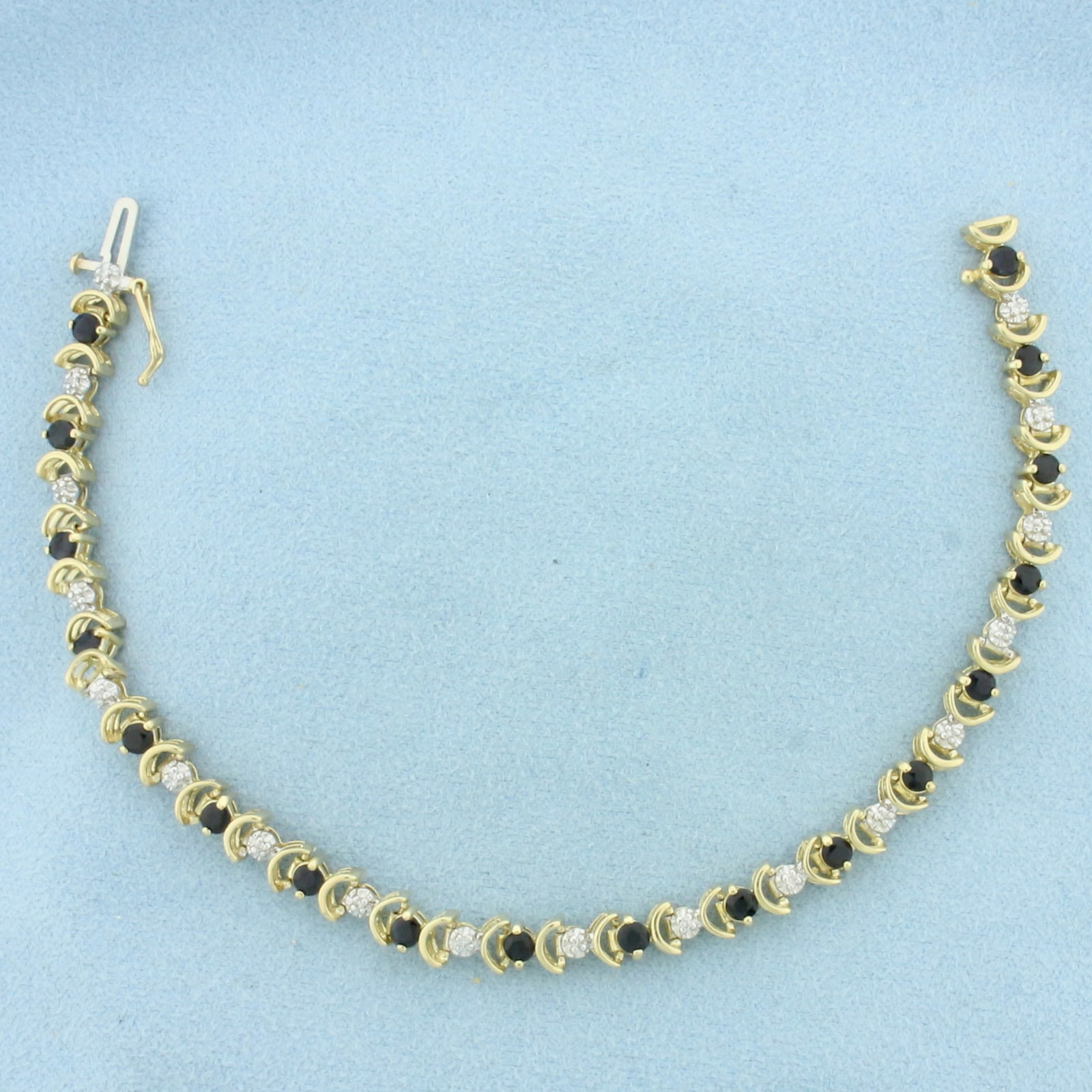 Sapphire and Diamond Tennis Bracelet in 10K Yellow Gold: In 10k yellow gold. Measures 7.5 inches long and 5.3mm wide. Contains 18 high quality natural 3mm Sapphire Gemstones, approximately 2ct TW, with deep color and excellent clarity. Also contains 18
