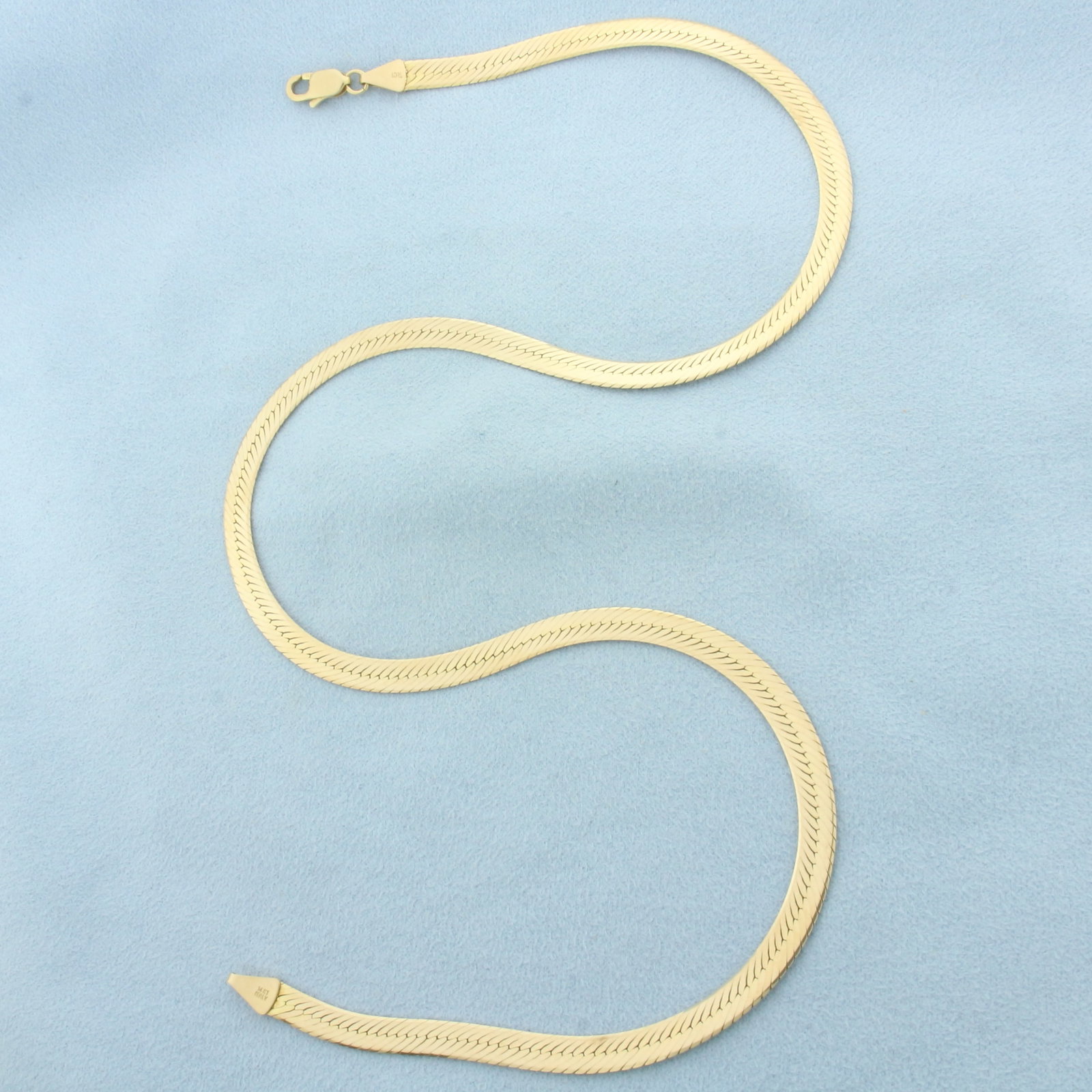 18 Inch Italian Herringbone Link Chain Necklace in 14k Yellow Gold: In 14k Yellow Gold. 18 inches long. 4.9mm wide. Italian made. Lobster clasp. 13.2g.