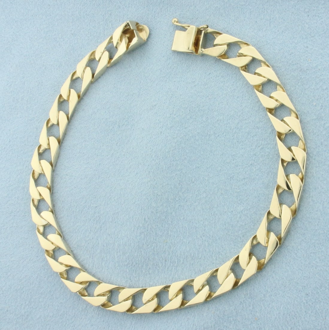 Squared Curb Link Bracelet in 14K Yellow Gold: In 14k yellow gold. 8.25 inches long by 6.7mm wide. Slide clasp with safety latch. 18.0g.