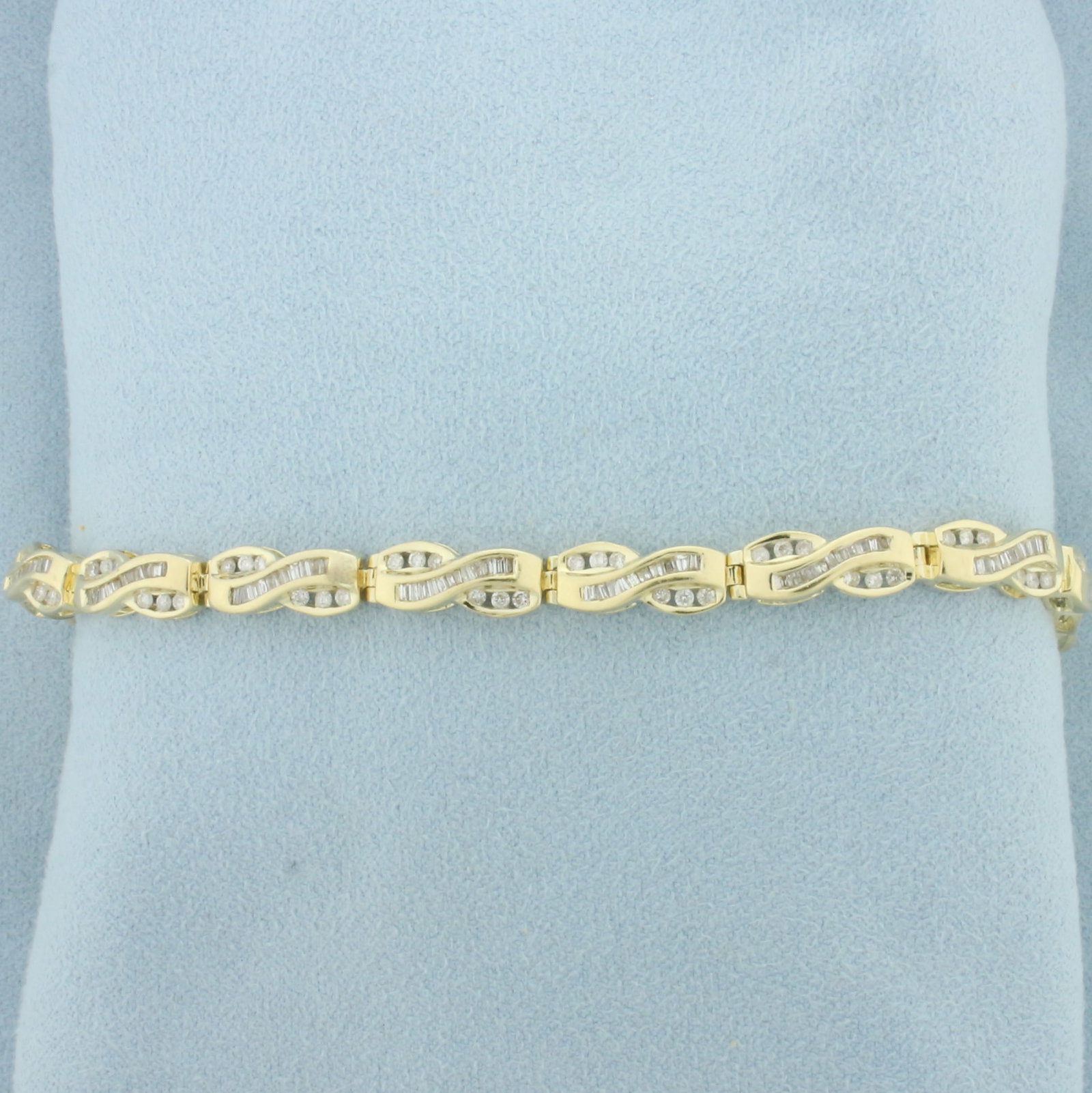 Baguette and Round Diamond Tennis Bracelet in 14k Yellow Gold: In 14k yellow gold. Contains 78 round brilliant and 130 baguette high quality diamonds, 2ct TW, I color/I clarity. 7 1/4 inches long, 5.6mm wide. Concealed slide clasp with safety latch and safety
