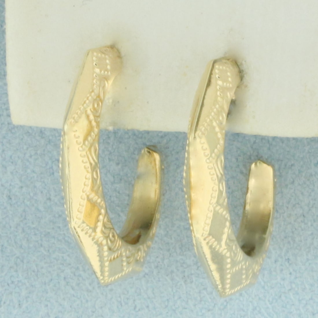 Unique Etched Hoop Earrings in 14k Yellow Gold: In 14k Yellow Gold. 7/8 inch long. 3/4 inch wide profile. Oversized friction backs for comfort. 3.1g.