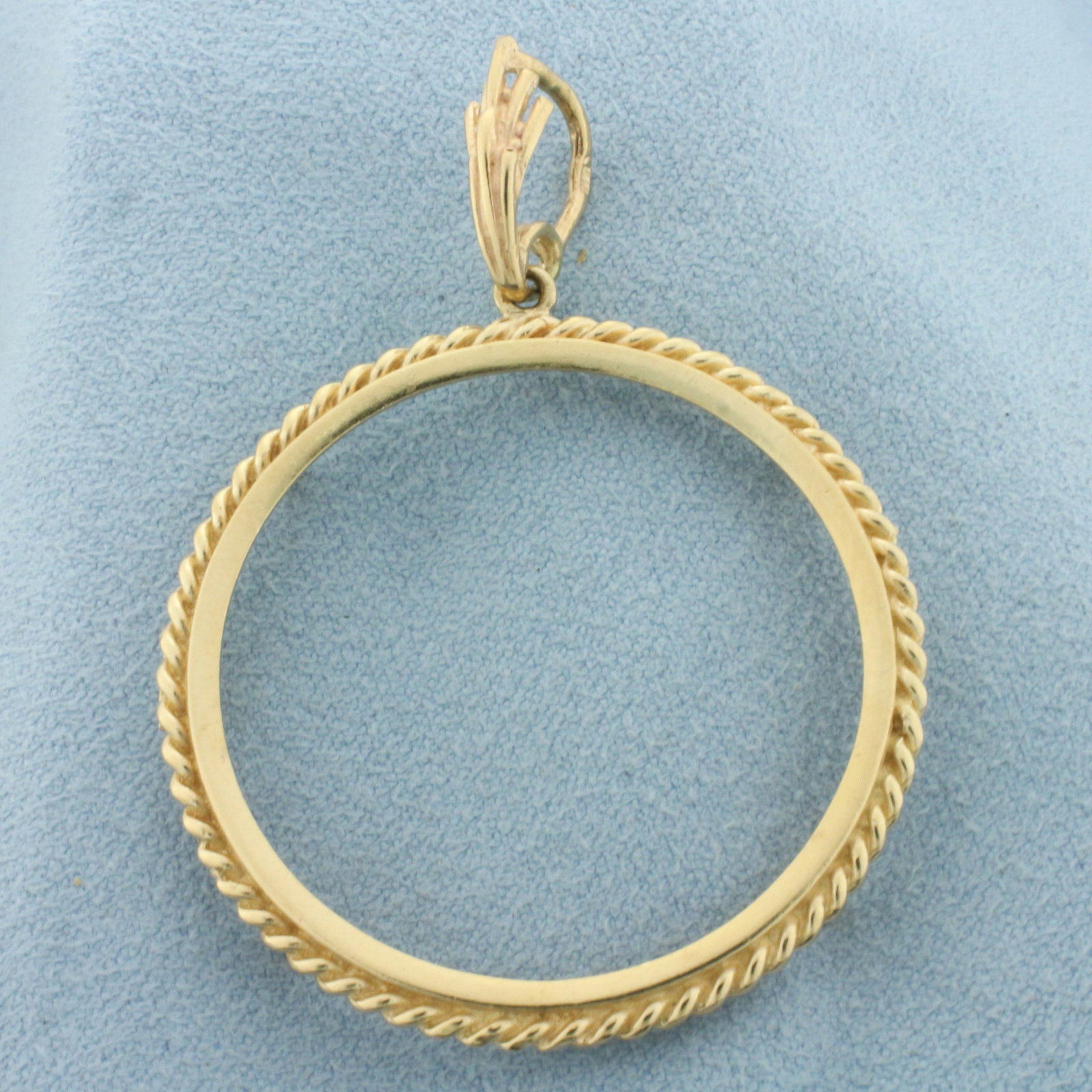 30mm Gold Maple Leaf Coin Bezel Pendant in 14k Yellow Gold: In 14k Yellow Gold. 2 inches long (including bale). 1 1/2 inch wide. Fits any 30mm gold coin like a Canadian 1oz Maple Leaf. 5.8g.
