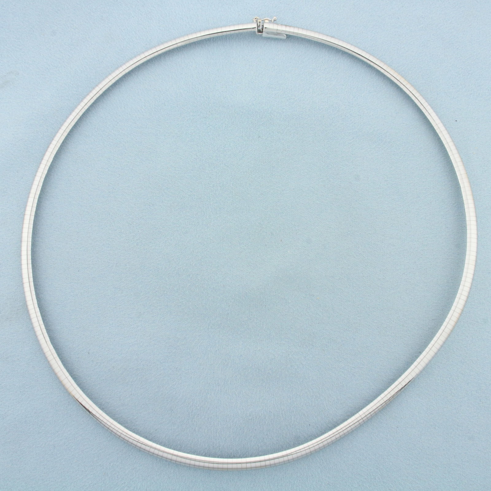 Italian 18 Inch Omega Necklace in 14k White Gold: In 14k white gold. Italian made. 18 inches long, 5mm wide. Concealed slide clasp with safety latch. 36.9g.