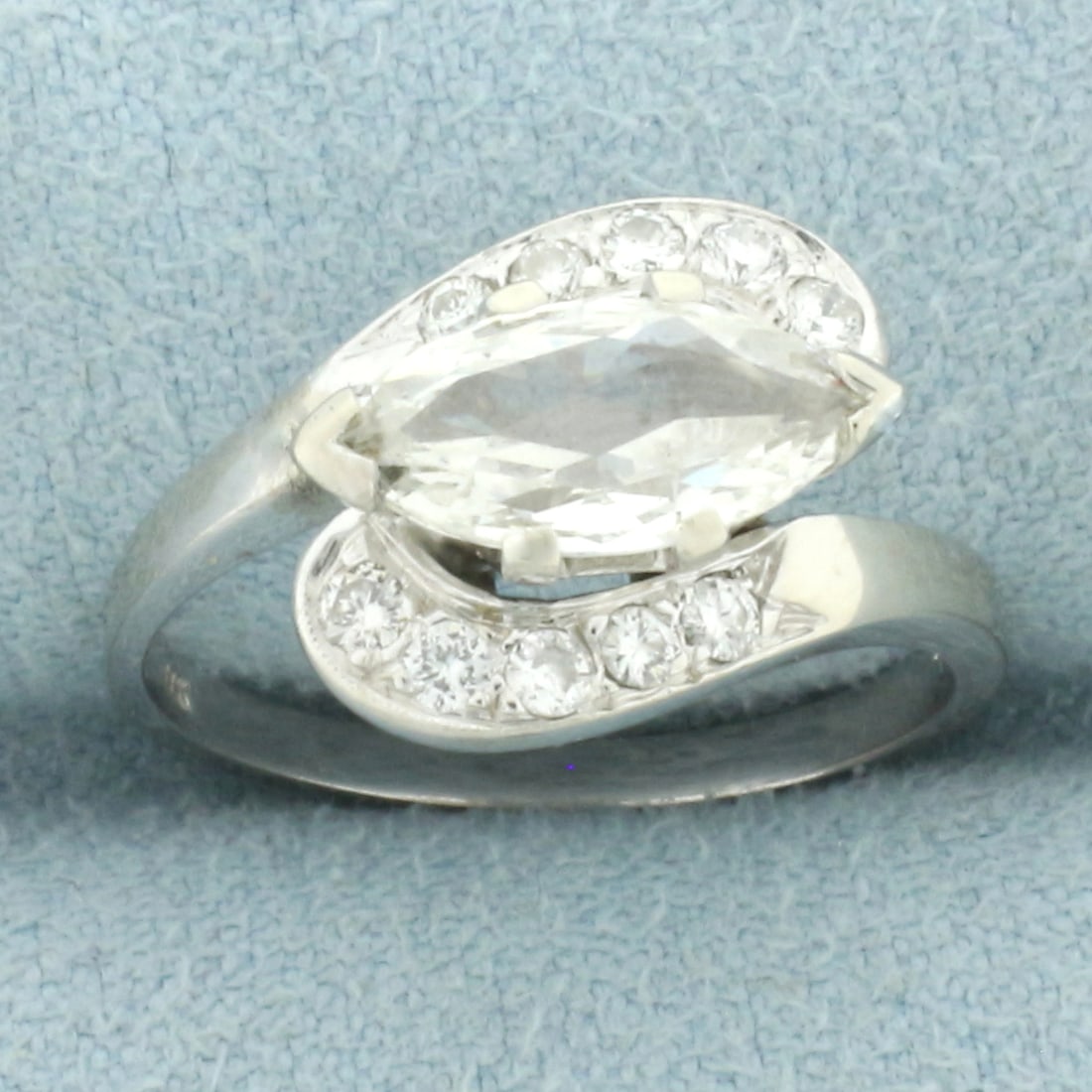 Horizontal Marquise Bypass Diamond Ring in 14k White Gold: In 14k white gold. Contains one high quality 11mm by 5mm marquise diamond, 3/4ct, SI2 Clarity/H color. Also contains ten high quality .02ct diamonds, SI1 clarity/H color. Size: 5.5. 3.6g.