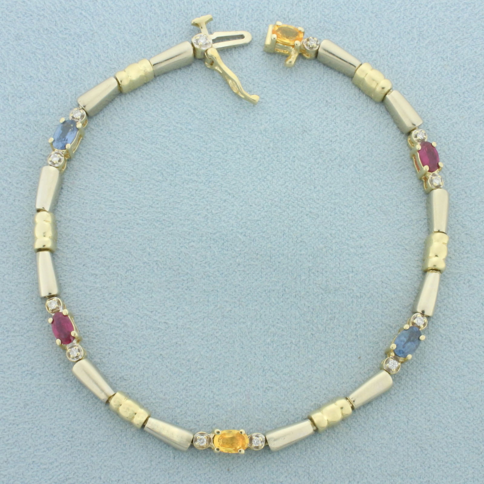 Sapphire and Diamond Two Tone Bracelet in 14k White and Yellow Gold: In 14k white and yellow gold. Contains two pink, two yellow, and two blue high quality natural 5mm by 3mm Sapphire gemstones with vibrant color and excellent clarity .Also contains twelve high quality