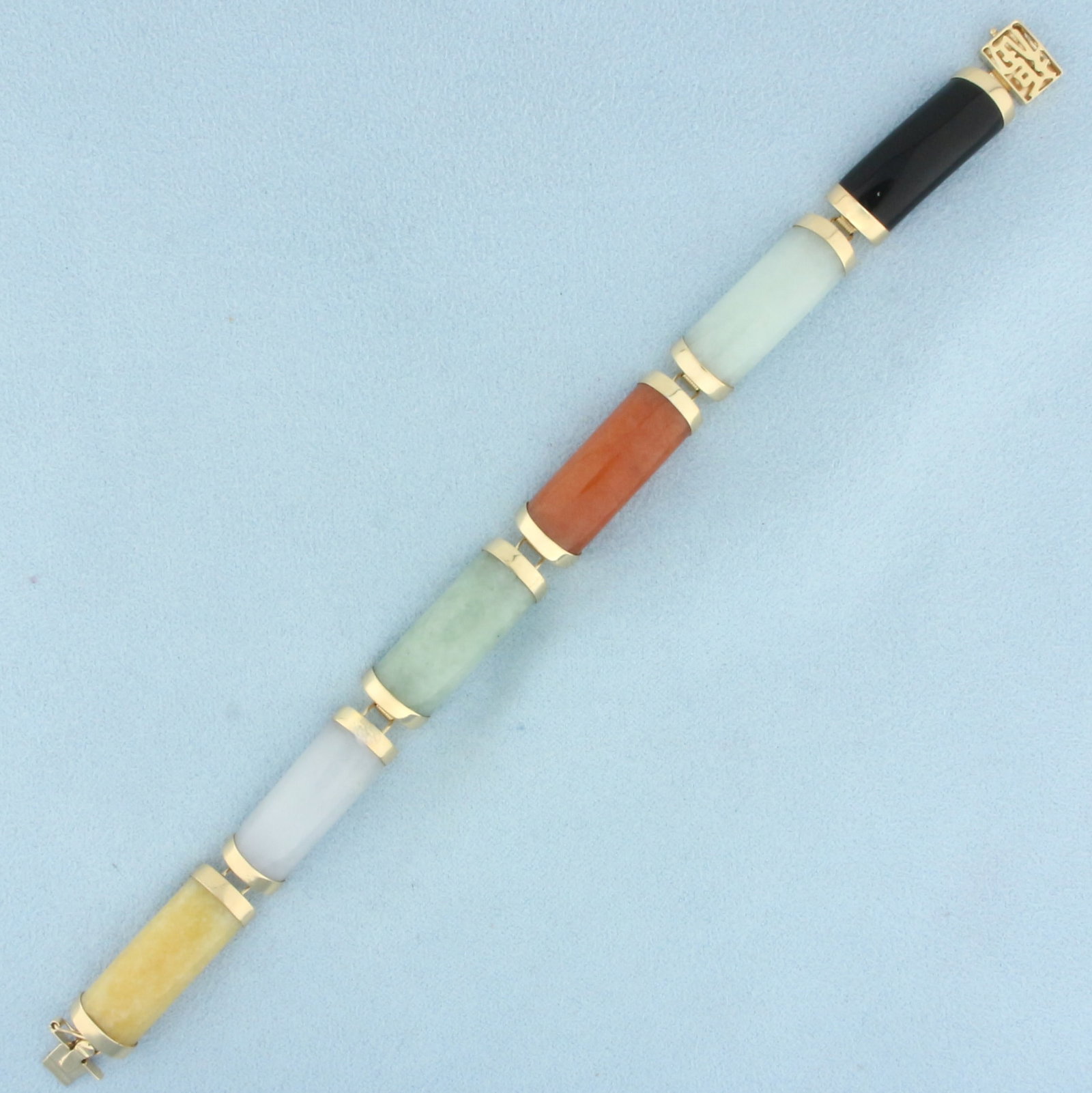 Multi Color Jade Good Fortune Link Bracelet in 14k Yellow Gold: In 14k yellow gold. Contains six high quality 21mm Jade gemstones with intense color. 7 inches long and 3/8 inches wide. Decorative slide clasp with Chinese good fortune symbol, safety latch.
