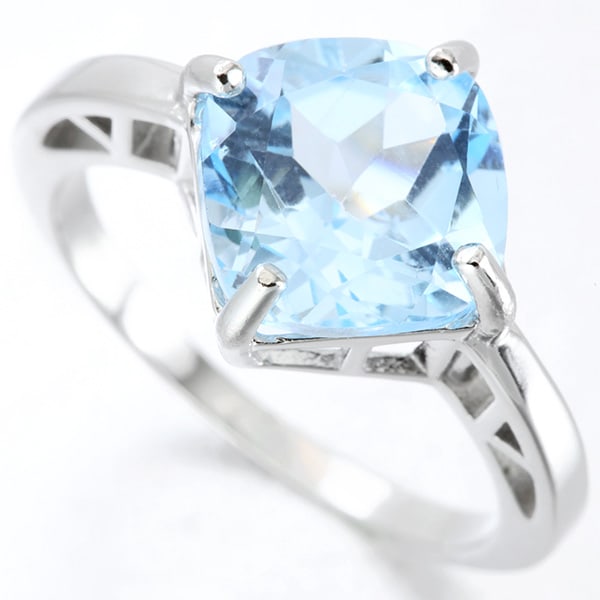 Large Blue Topaz Solitaire Ring in Sterling Silver: In platinum over .925 sterling silver. Contains one 5.2ct blue topaz gemstone. Size 8. 3.9g