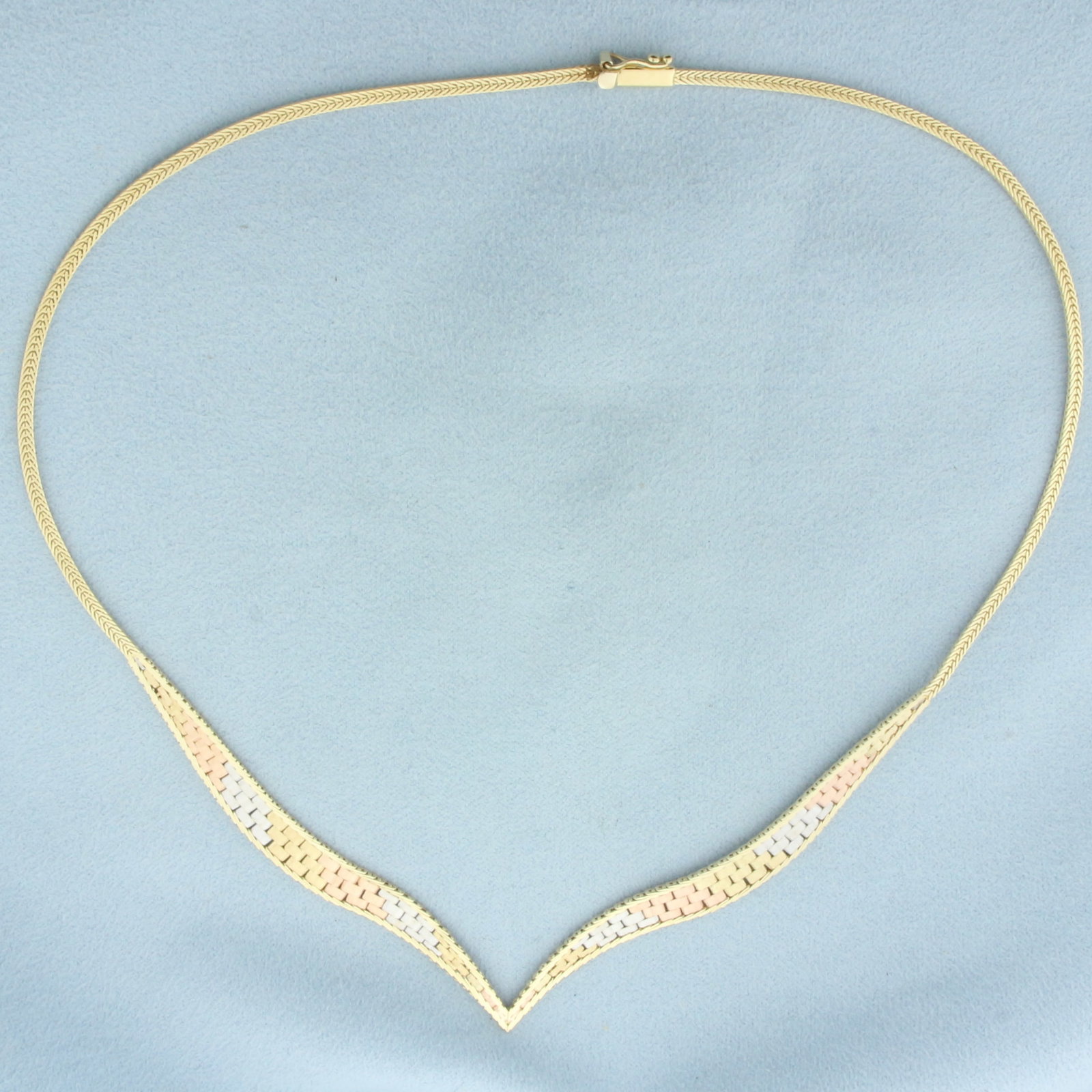 Tri-Color Italian V Necklace in 14k Yellow, White, and Rose Gold: In 14k Yellow, White, and Rose Gold. 16 inches long. 6.6mm wide at widest part of chain. Italian made. Slide clasp with safety latch. 10.6g.