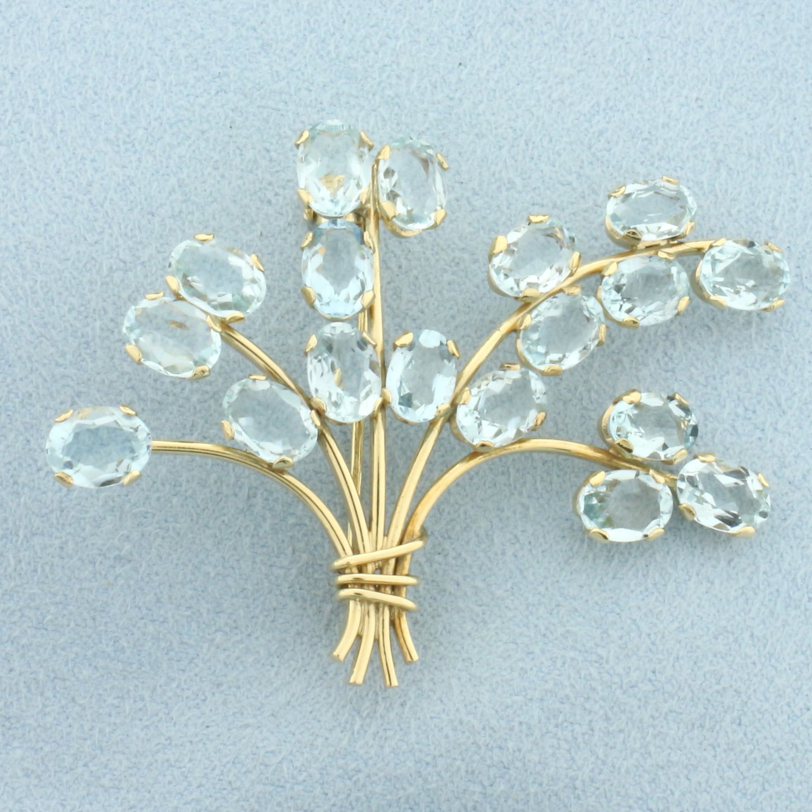 Vintage Aquamarine Flower Bouquet Brooch Pin in 18k Yellow Gold: In 18k Yellow Gold. Contains eighteen 7mm high quality natural oval cut aquamarine gemstones with bright color and excellent clarity. 2 1/8 inch wide. 1 1/2 inch long. 9.1g.