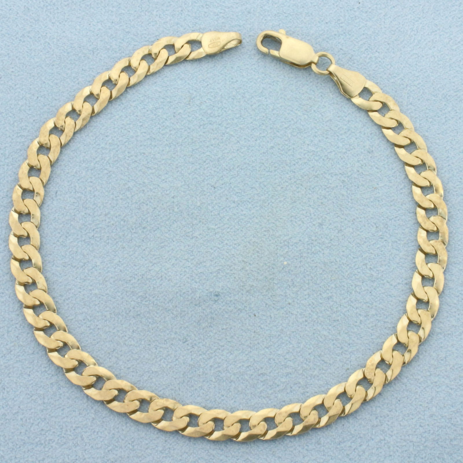 Italian Curb Link Bracelet in 10k Yellow Gold: In 10k Yellow Gold. 8 1/4 inches long. 5.1mm wide. Italian made. Lobster clasp. 6.4g.