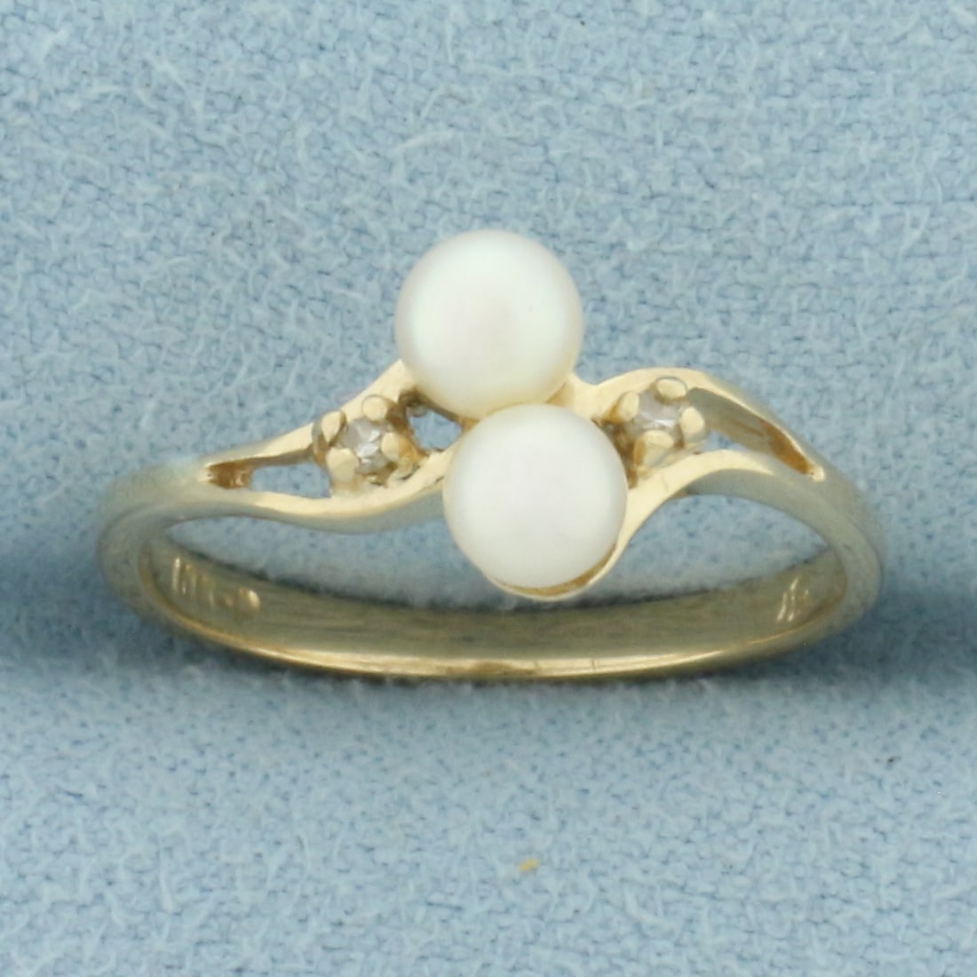 Cultured Pearl and Diamond Ring in 10k Yellow Gold: In 10k Yellow Gold. Contains two high quality 4mm cultured pearls with high luster. Also contains two high quality 1/2pt diamonds. Size 6. 1.6g.