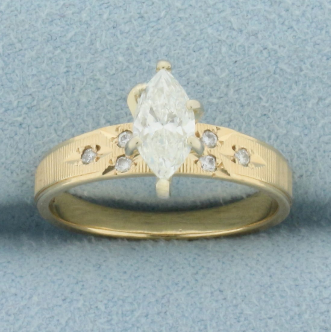 Vintage Marquise Diamond Engagement Ring in 14k Yellow Gold: In 14k Yellow Gold. Contains one high quality 3/4ct marquise diamond, SI clarity/I color, eye clean, great cut for added brilliance. Also contains and six .01ct round diamonds of similar high quality.