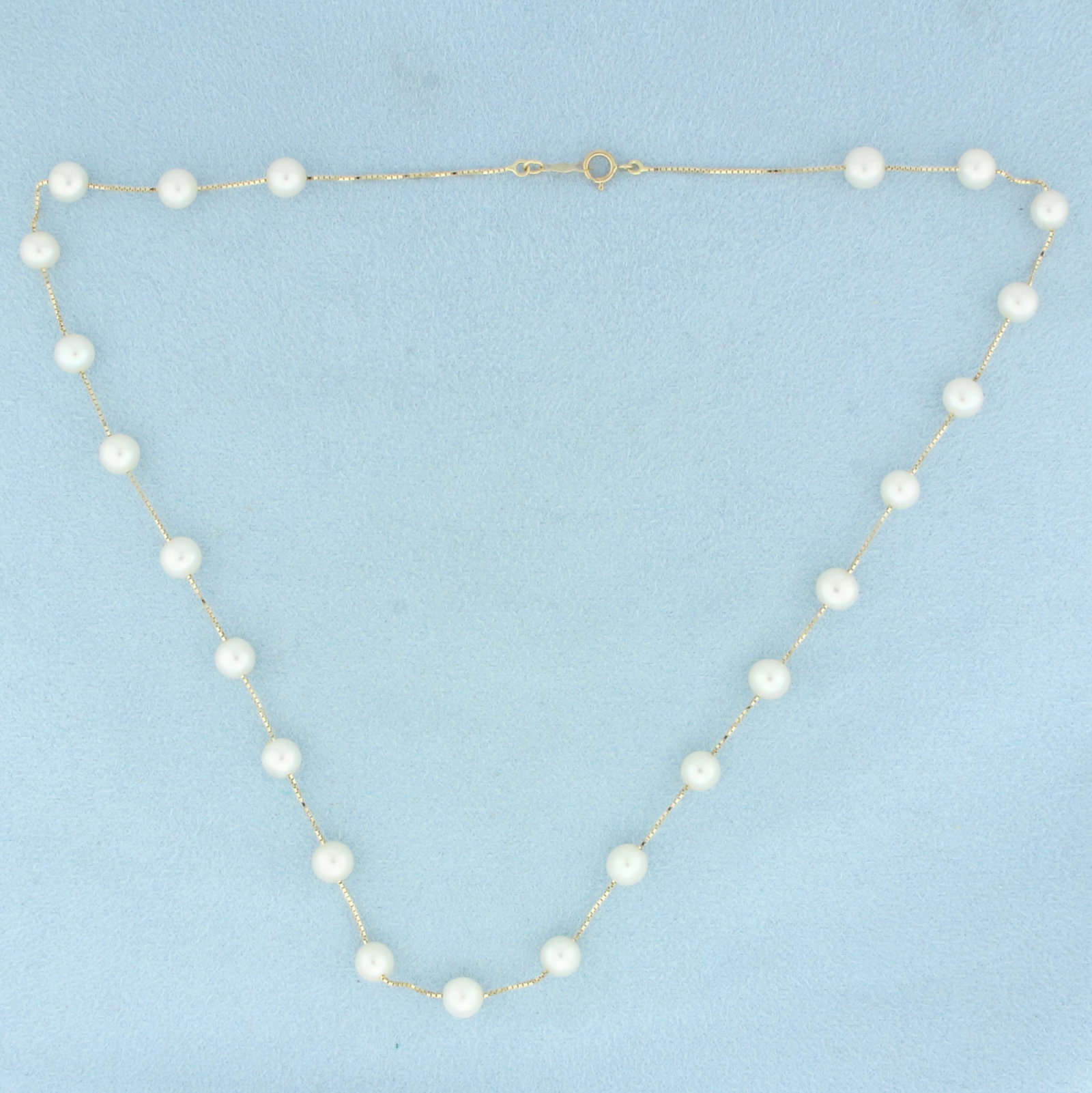 Akoya Pearl Station Necklace in 14k Yellow Gold: In 14k Yellow Gold. Contains twenty three 5.5mm high quality Cultured Akoya Pearls with high luster. 17 inches long. Spring clasp. 7.1g.