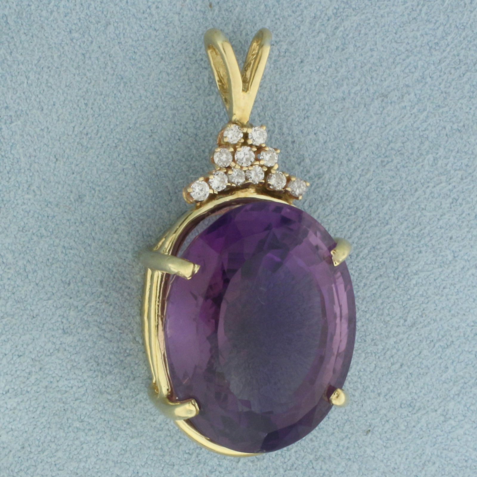 Large Amethyst and Diamond Statement Pendant in 14k Yellow Gold: In 14k Yellow Gold. Contains one 24x19mm high quality oval fancy cut natural Amethyst gemstone, approximately 30cts, with vibrant color and excellent clarity. Contains eleven .02ct high quality diamon