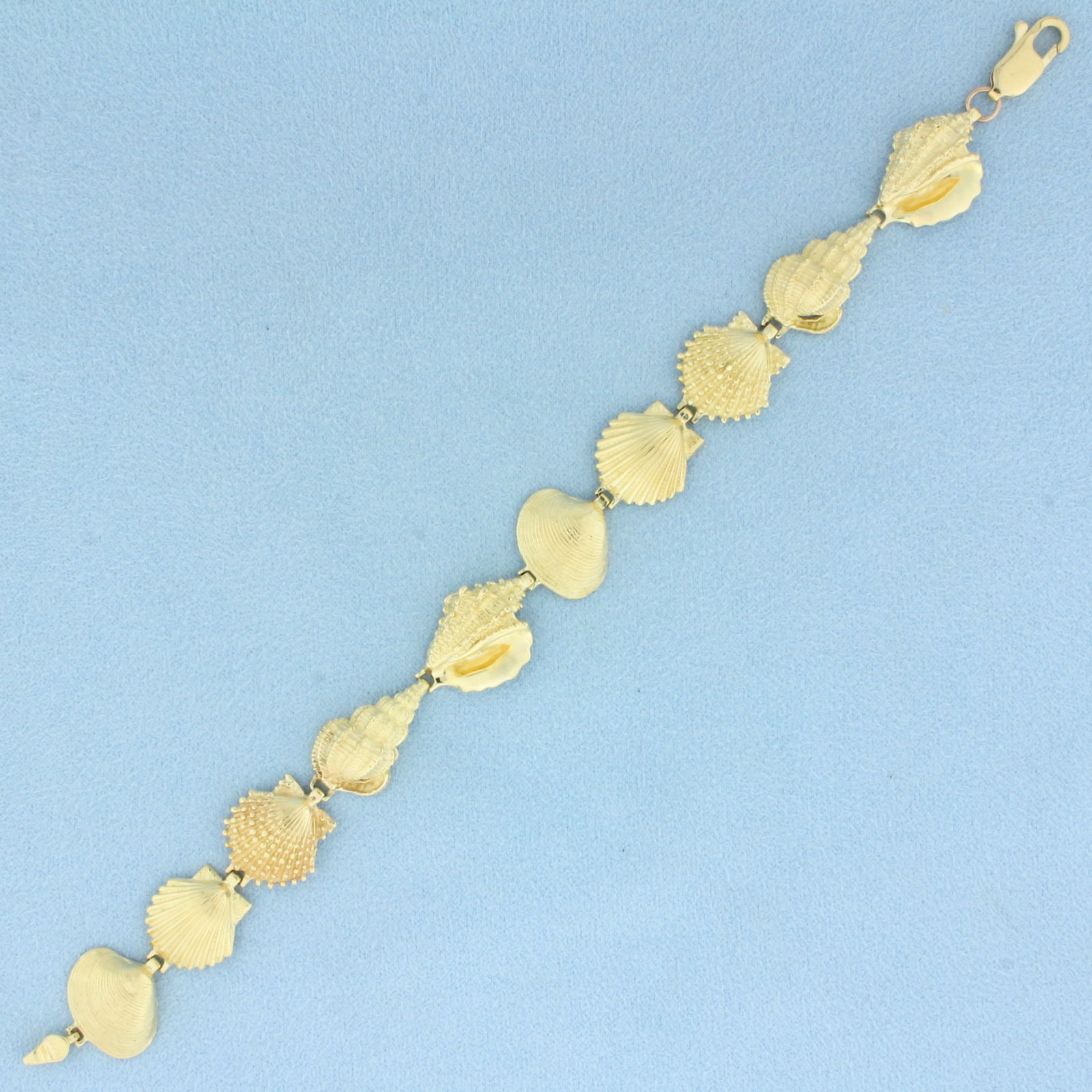 Seashell Bracelet in 14k Yellow Gold: In 14k Yellow Gold. 7 1/2 inches long. 1/2 inch wide. Lobster clasp. 17.7g.