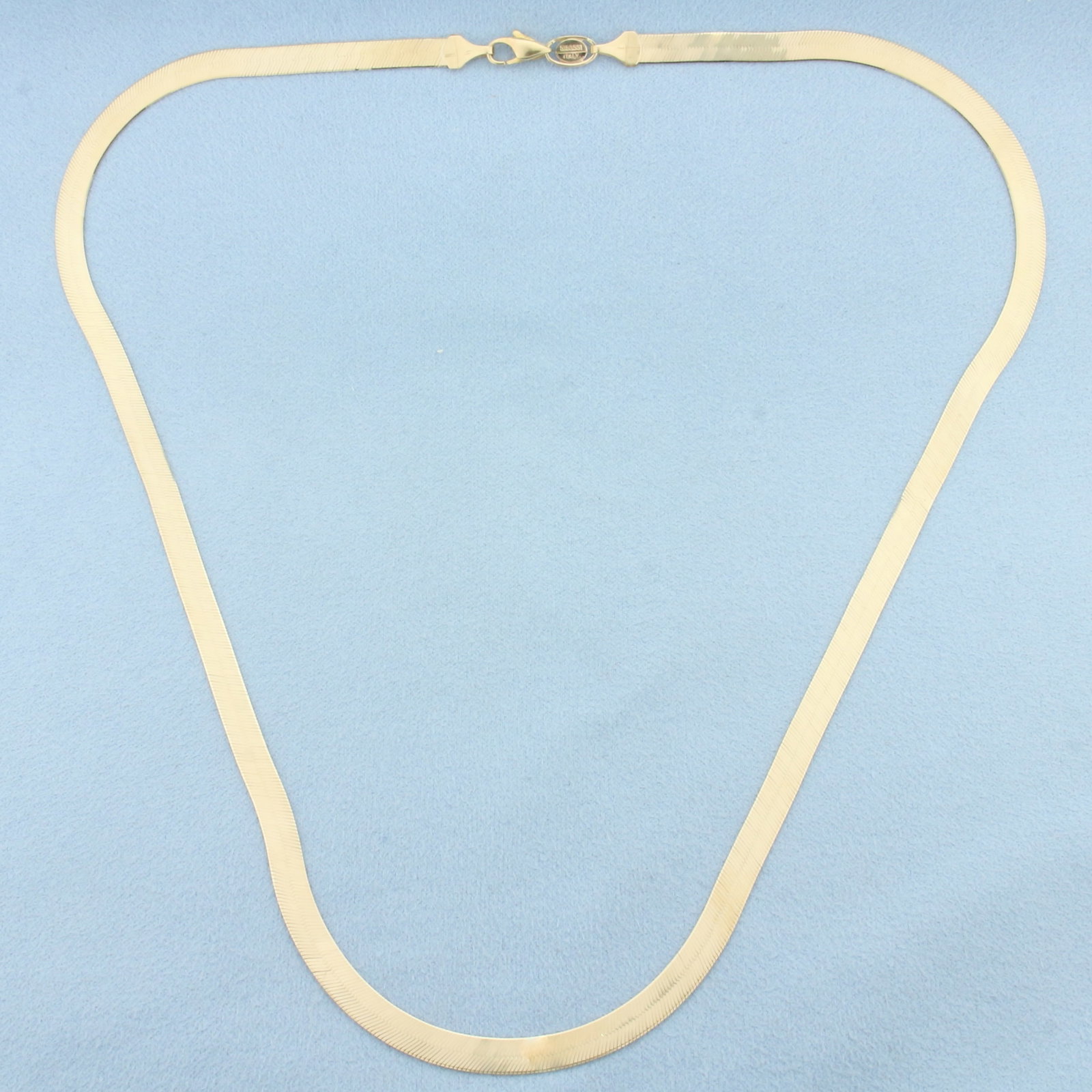 20 Inch Italian Liquid Gold Herringbone Link Chain Necklace in 14k Yellow Gold: In 14k Yellow Gold. 20 inches long. 4.8mm wide. Italian made. Lobster clasp. 10.1g.