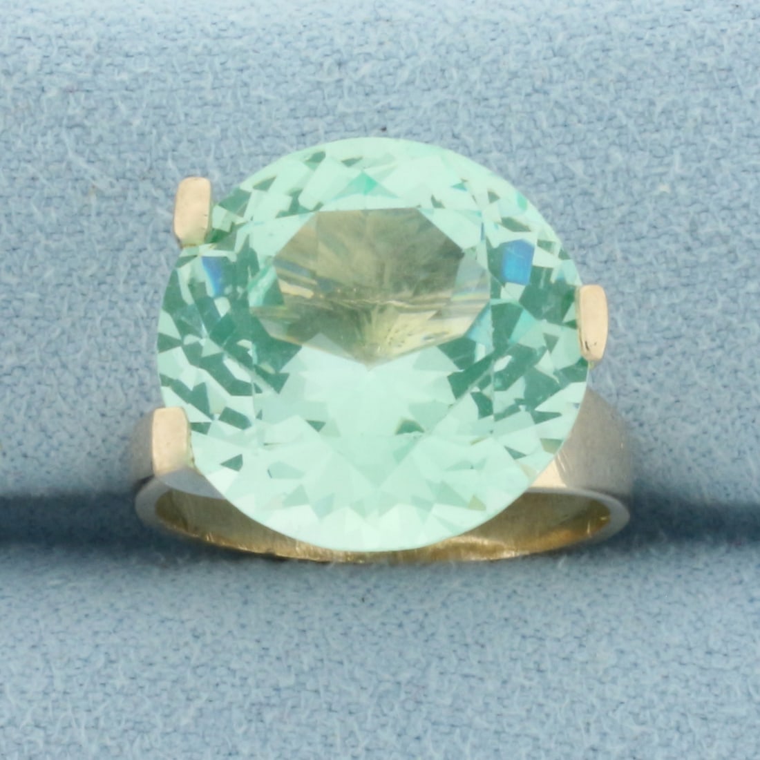 Mint Green Tourmaline Solitaire Ring in 14k Yellow Gold: In 14k yellow gold. Contains one high quality natural 14.6mm Mint Green Tourmaline gemstone with excellent clarity and bright color. Unique modern 3-prong setting. Size 5.5. 5.3g.