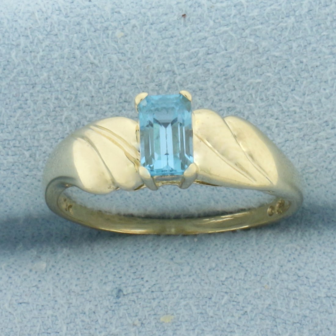 Swiss Blue Topaz Ring in 10k Yellow Gold: In 10k Yellow Gold. Contains one high quality 6x4mm high quality natural Swiss Blue Topaz gemstone with electric blue color and excellent clarity. Size 8. 2.3g.