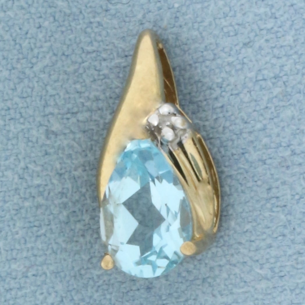 Sky Blue Topaz and Diamond Pendant in 14k Yellow Gold: In 14k Yellow Gold. Contains one 9mm high quality natural Sky Blue Topaz gemstone, approximately 2cts, with bright color and excellent clarity. Also contains one .01ct high quality diamond. 1/2 inch l