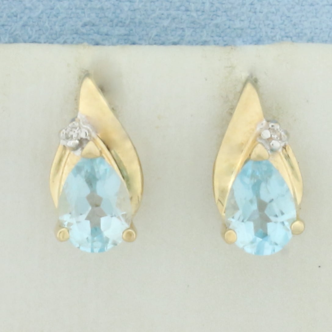 Sky Blue Topaz and Diamond Earrings in 14k Yellow Gold: In 14k Yellow Gold. Contains two 5x7mm high quality pear natural Sky Blue Topaz gemstones with bright color and excellent clarity. Also contains two high quality 1/2pt diamonds. 1/2 inch long. 1/4 inc