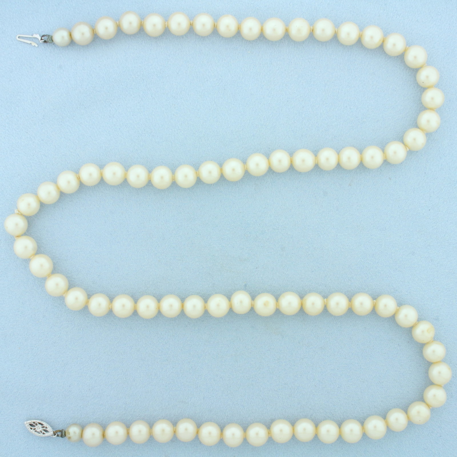 Vintage Akoya Pearl Strand Necklace in 14k White Gold Filigree Clasp: In 14k White Gold Filigree Clasp. Contains high quality 7.75-8mm cultured akoya pearls with high luster. 25 inches long. Hand knotted.