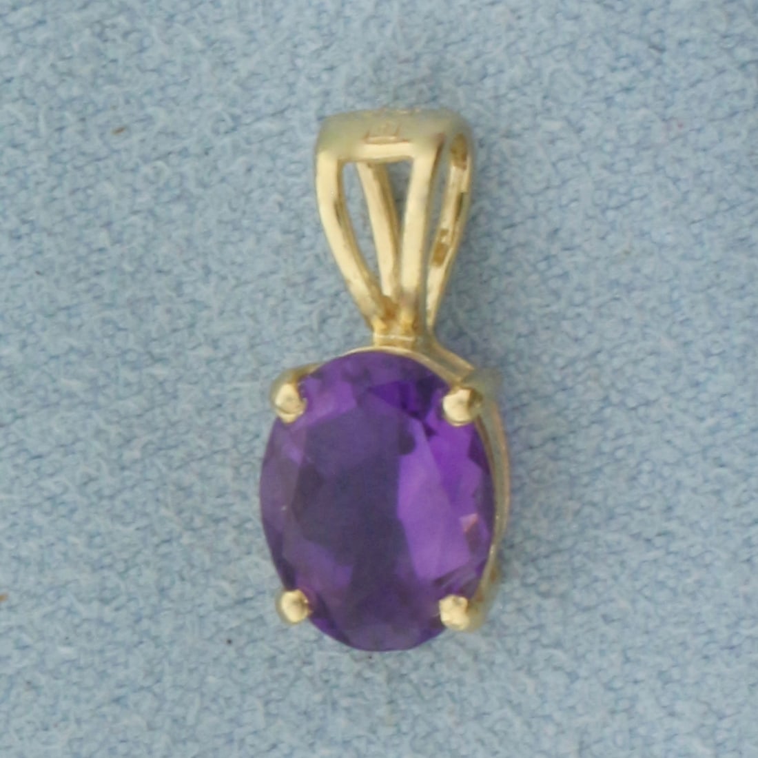 Amethyst Pendant in 14k Yellow Gold: In 14k Yellow Gold. Contains one 9mmx7mm high quality natural amethyst gemstone with intense color and excellent clarity. 9/16 inch long. 1/4 inch wide. 1.0g.