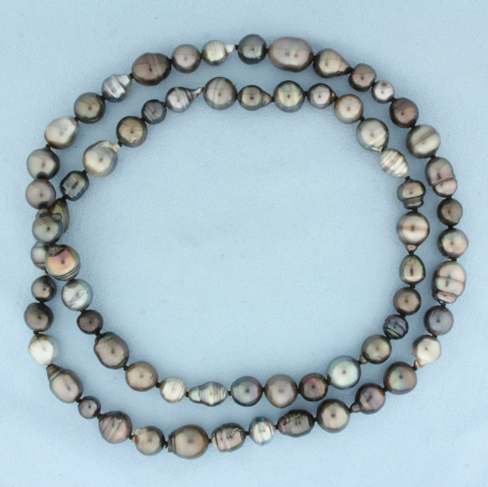 Tahitian Pearl Baroque Hand Knotted Pearl Strand Necklace: 32 inches long. Contains 10 to 11.5mm high quality Tahitian baroque pearls with high luster and beautiful peacock undertones. Hand knotted. 108.8g.
