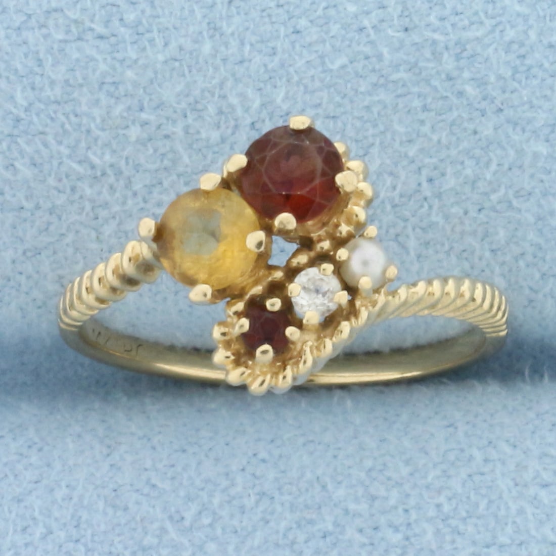 Diamond, Garnet, Citrine, and Seed Pearl Ring in 14k Yellow Gold: In 14k yellow gold. Contains one 4mm Garnet gemstone, one 1.7mm Garnet gemstone, one 4mm Citrine gemstone, and one 2mm Seed Pearl, all high quality with vibrant color. Also contains one .03ct diamond,