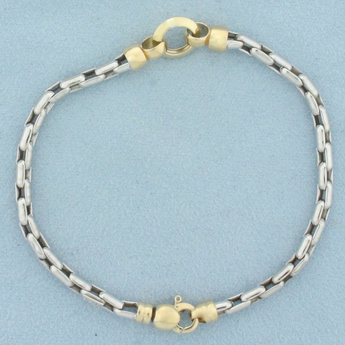 Two Tone Designer Cable Link Bracelet in 14k White and Yellow Gold: In 14k White and Yellow Gold. 7 5/8 inches long. 3.5mm thick. Lobster clasp. 6.8g.