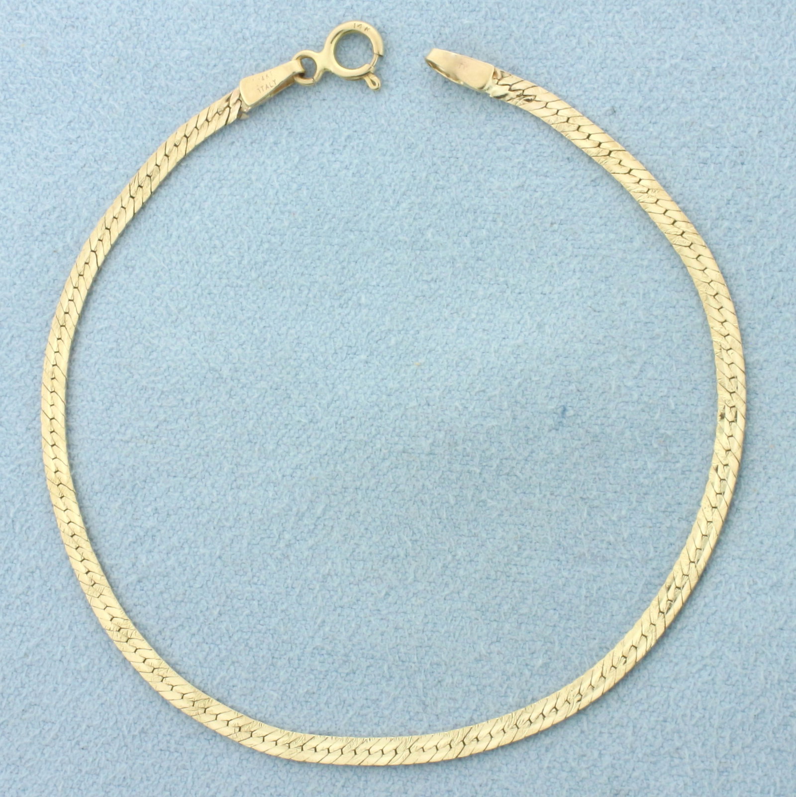 Italian Diamond Cut Herringbone Bracelet in 14k Yellow Gold: In 14k Yellow Gold. 6 3/4 inches long. 2.2mm wide. Italian made. Diamond cut textured pattern for unique look. Spring clasp. 1.6g.