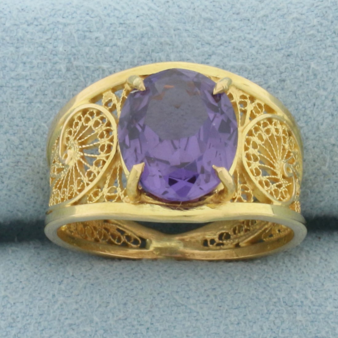 Color Changing Lab Alexandrite Ring in 18k Yellow Gold: In 18k Yellow Gold. Contains one 11x9mm high quality oval cut natural color changing Lab Sapphire gemstone, approximately 3.5cts, with dramatic color shift from purple to pink. Size 7. 5.0g