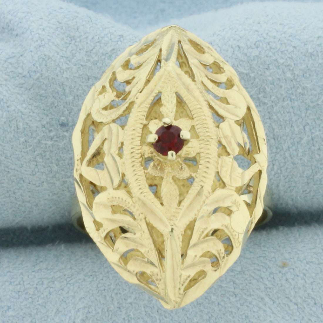 Vintage Ruby Filigree Ring in 10k Yellow Gold: In 10k Yellow Gold. Contains one 3mm high quality Ruby gemstone, approximately .1ct, with intense color. 1 1/8 inch long. 5/8 inch wide at top of ring. Size 9.5. 4.7g.