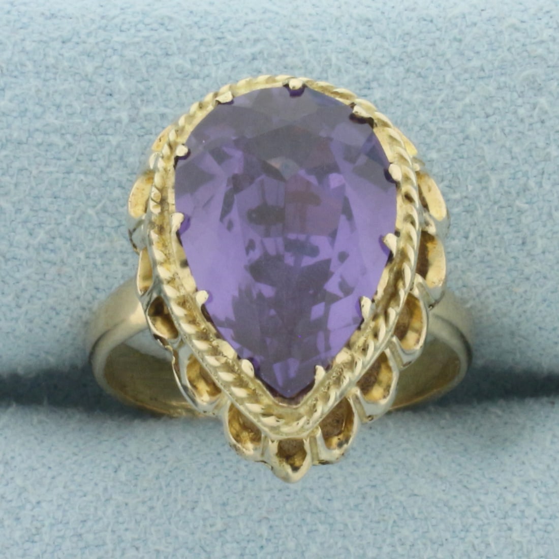 Color Changing Lab Alexandrite Ring in 14k Yellow Gold: In 14k Yellow Gold. Contains one 15x10mm high quality pear cut color changing Lab Alexandrite gemstone, approximately 5cts, with dramatic color changing from purple to pink. Size 6.5. 5.7g.