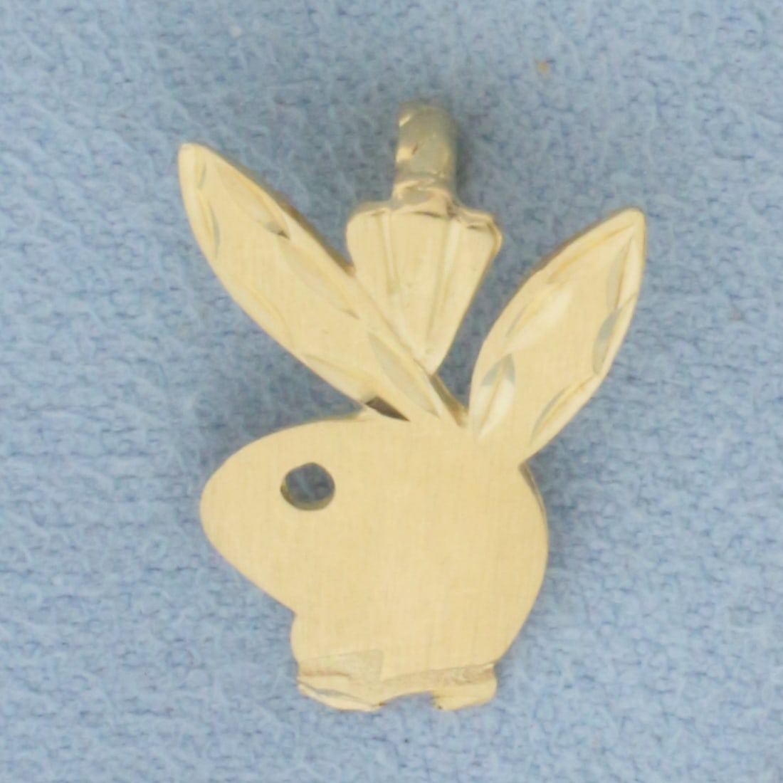 Playboy Bunny Pendant in 14k Yellow Gold: In 14k Yellow Gold. 5/8 inch long. 1/2 inch wide at widest. 0.9g.