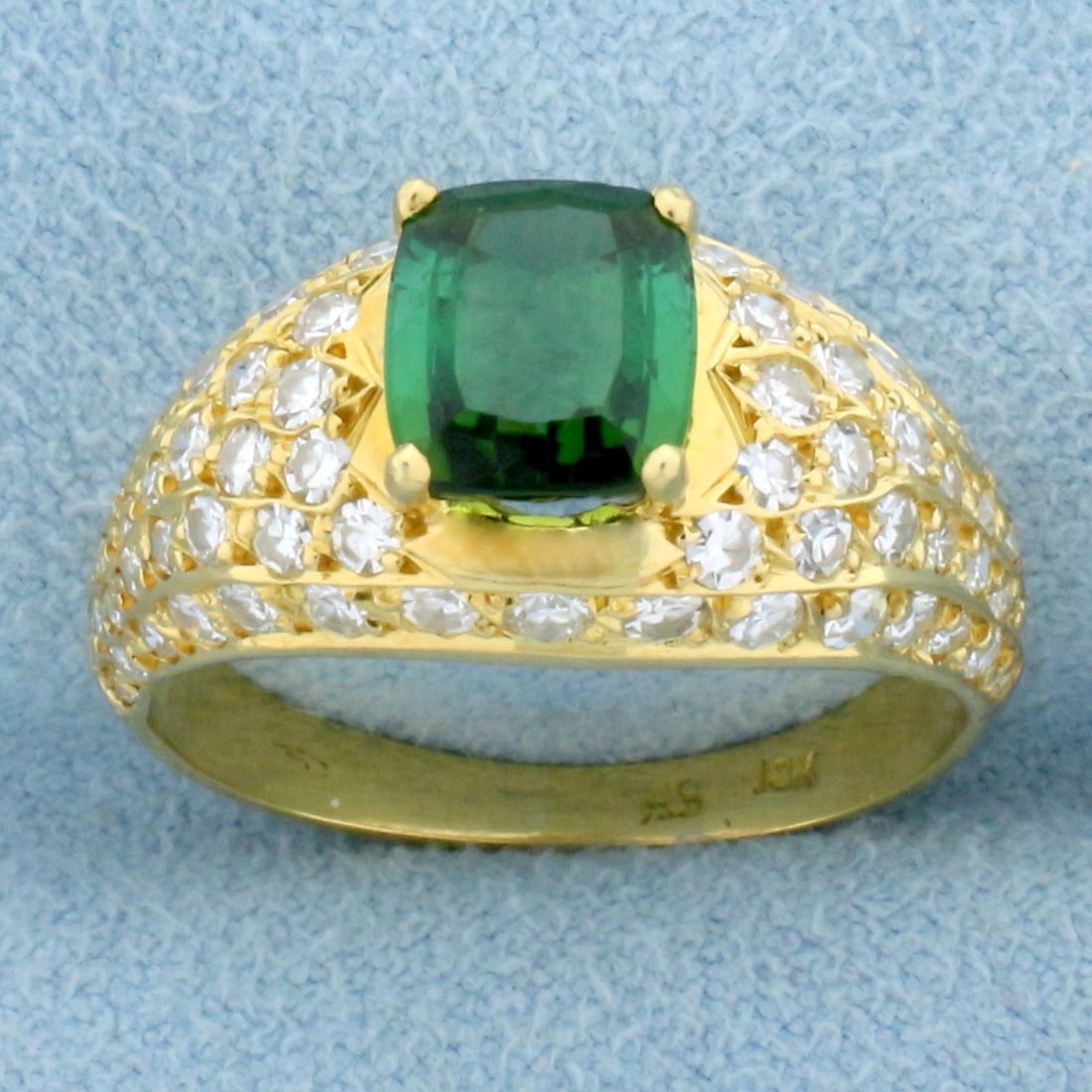 Tsavorite Garnet and Diamond Ring in 18K Yellow Gold: In 18K Yellow Gold. Contains one high quality natural 7.35x6.35mm, 1.5ct, Tsavorite Garnet gemstone with intense green color and excellent clarity. Also contains eight six high quality Diamonds, 3/4ct