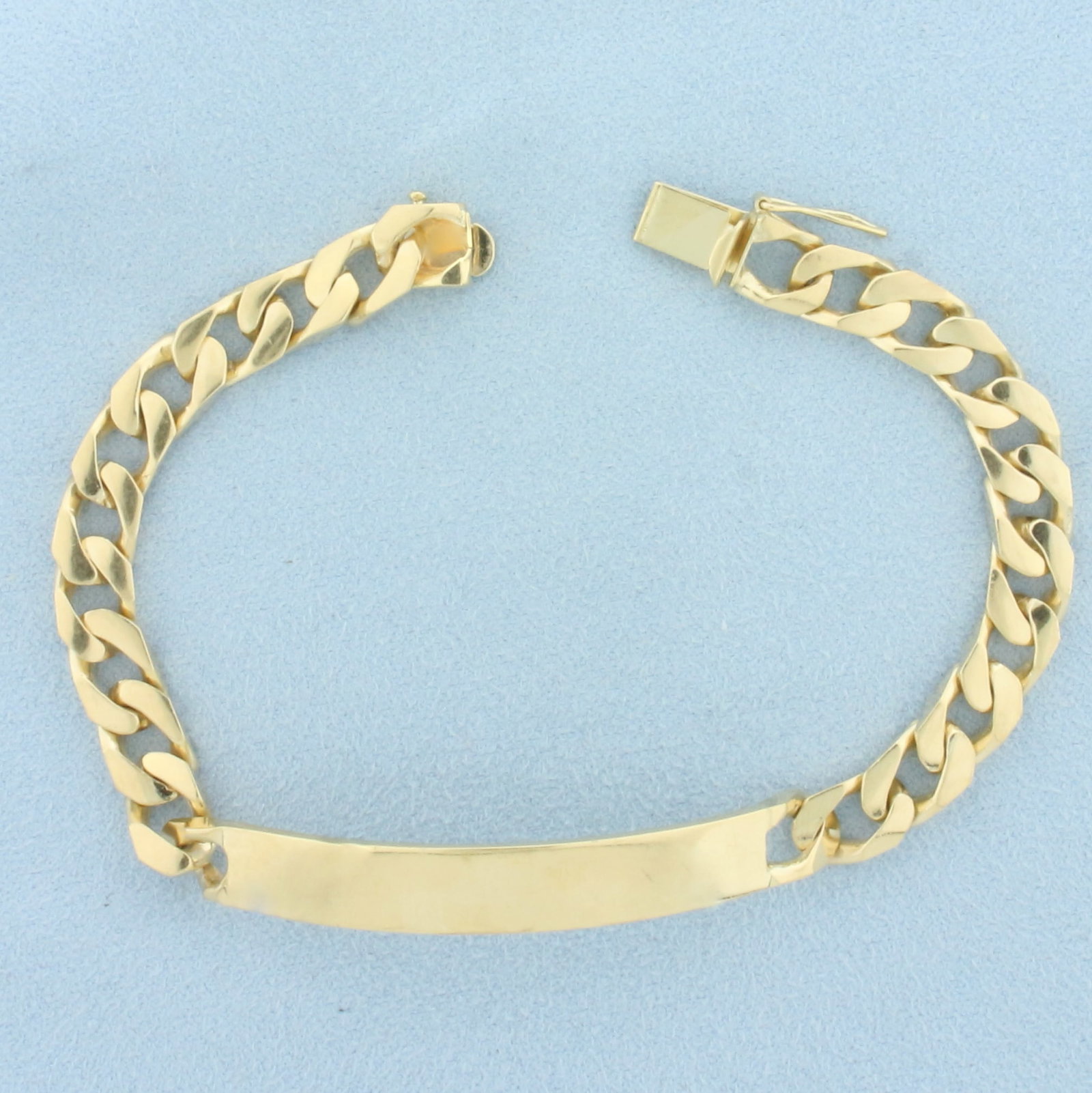 Curb Link ID Name Bracelet in 14k Yellow Gold: In 14k Yellow Gold. 8 inches long. 8mm wide. Engravable area 2 inches long. Slide clasp with safety latch. 29.9g.
