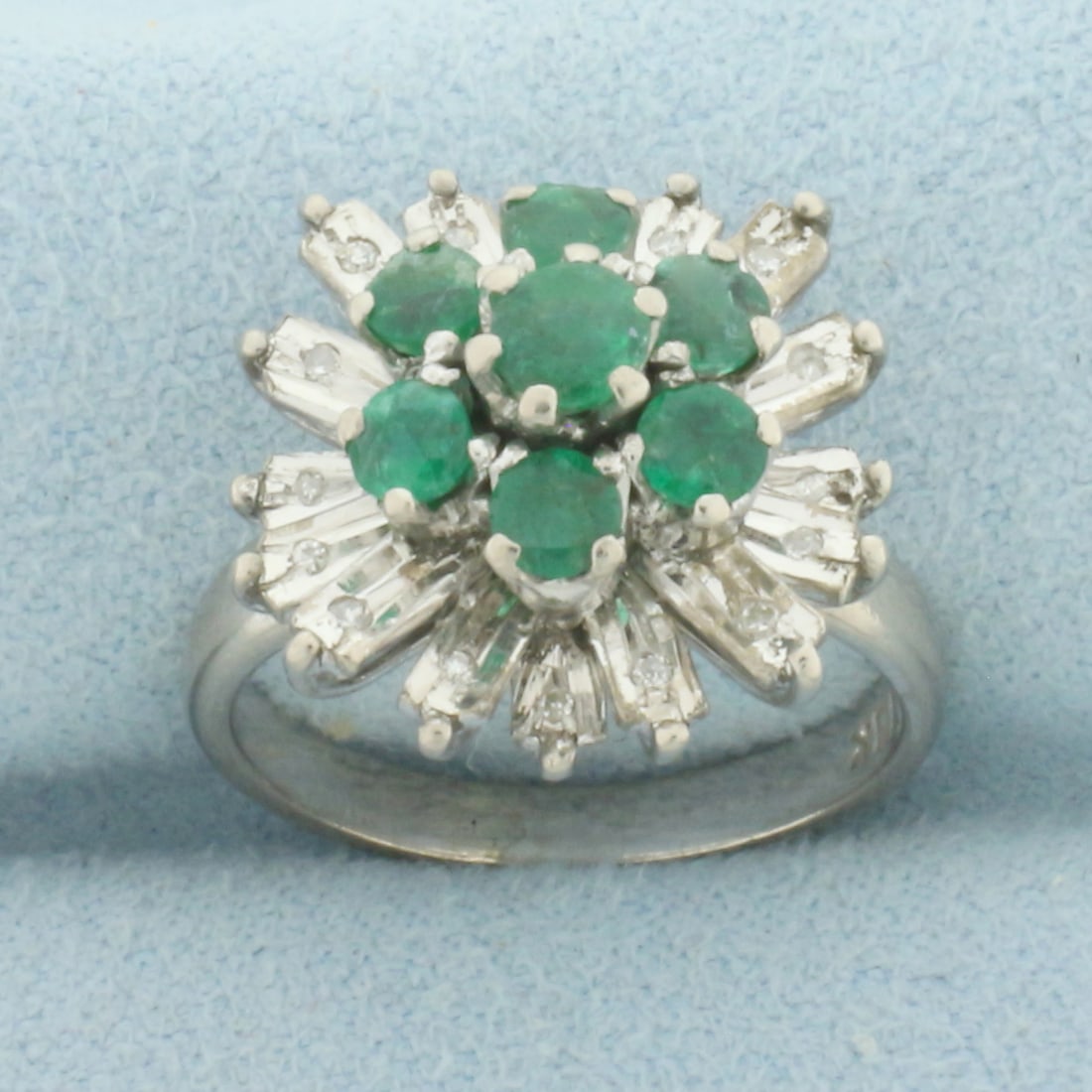 Emerald and Diamond Starburst Ring in 18k White Gold: In 18k White Gold. Contains one 4mm and six 3.5mm high quality natural Emerald gemstones with intense color. Also contains sixteen high quality 1/2pt diamonds. 16mm wide at top of ring. Size 4.5. 5.9g