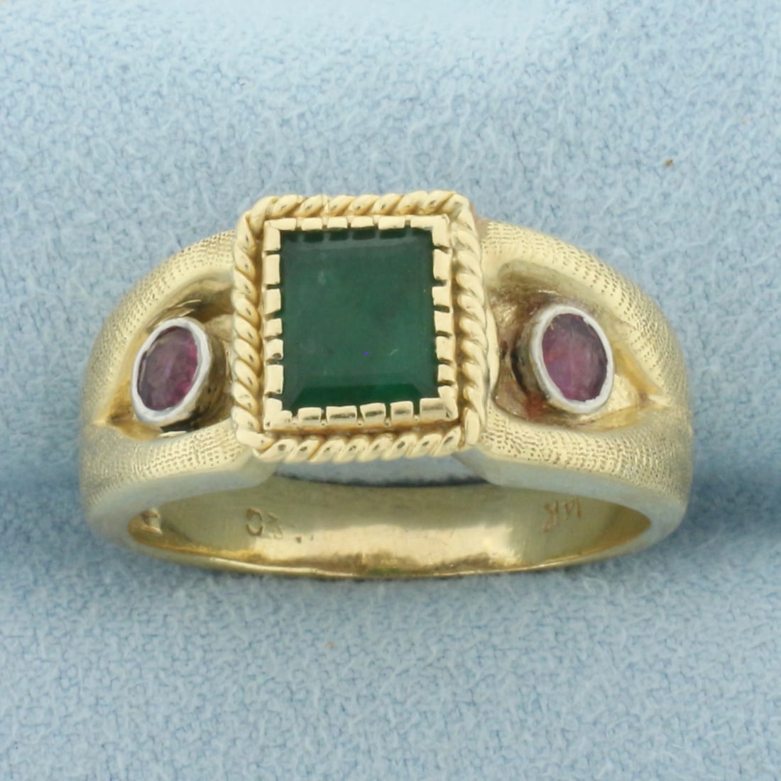 Mens Vintage Emerald and Ruby Ring in 14k Yellow Gold: In 14k Yellow Gold. Contains one 8x6mm high quality natural Emerald gemstone with intense color. Also contains two 3.5mm high quality natural Ruby gemstones with vibrant color. 10.4mm wide at top of r