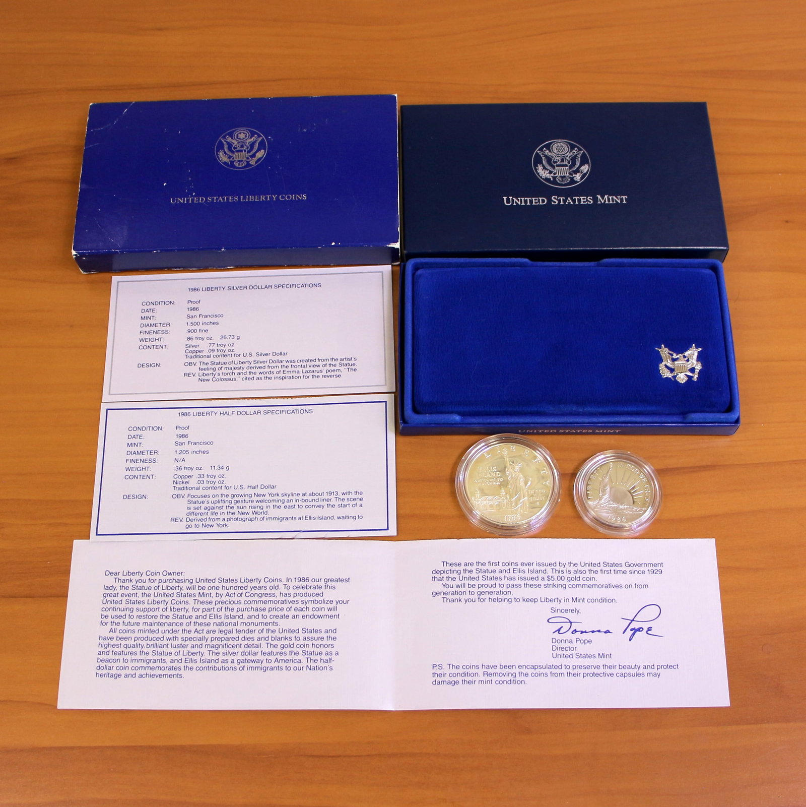 1986 US Mint Liberty Two Silver Coin Set OGP: Contains one 1986 90% Silver Liberty Silver Dollar. Also contains one 1986 Liberty Half Dollar. Set in original government packaging and contains certificate of authenticity.