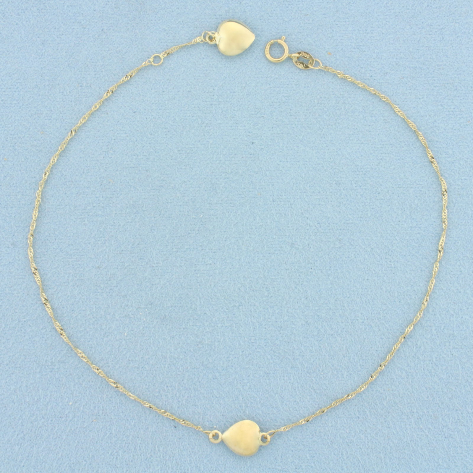 Puffy Heart Anklet in 14k Yellow Gold: In 14k Yellow Gold. 9 1/4 inches long. 1mm wide curb link. 7.5mm heart charms. Italian made. Spring clasp. 1.1g.