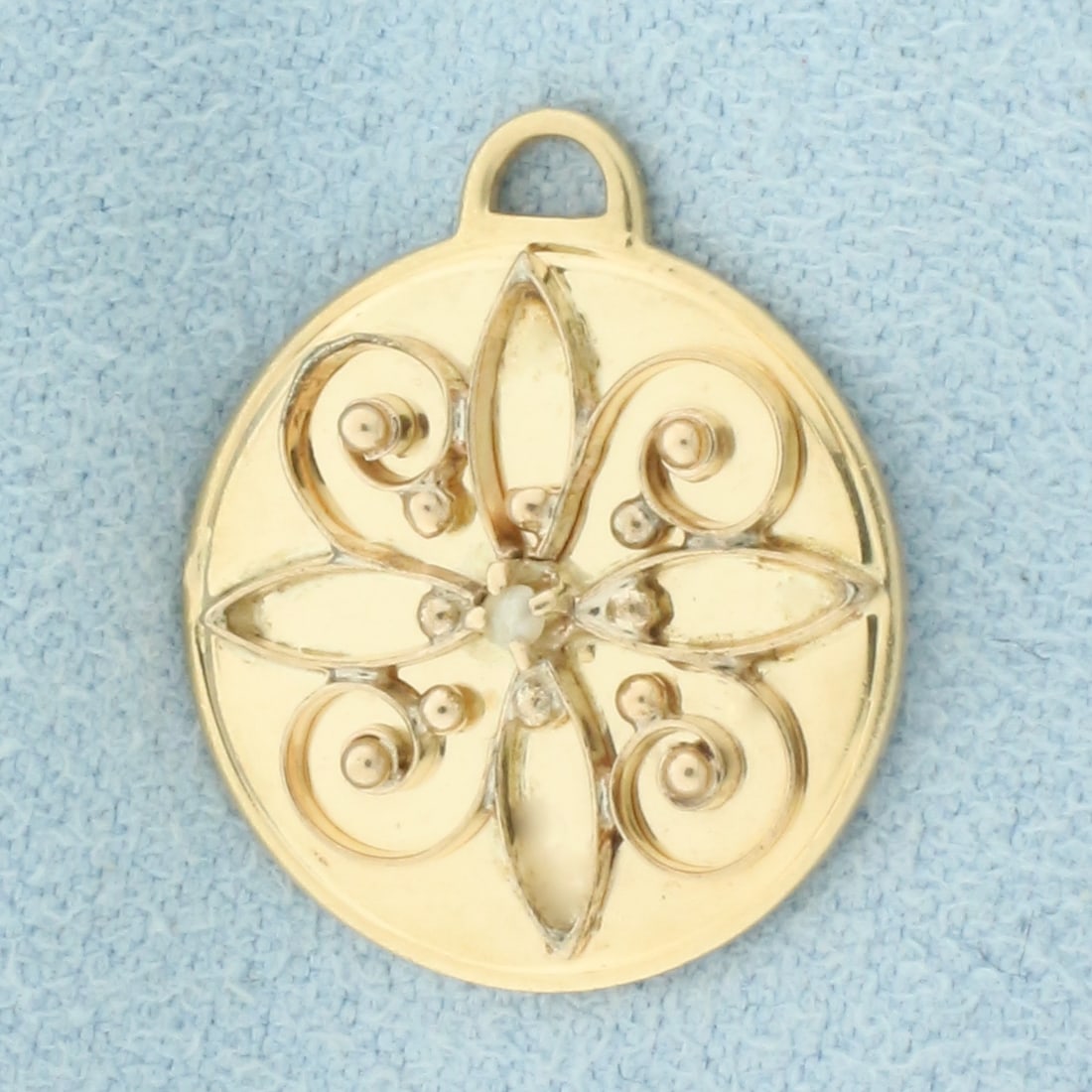 Vintage Seed Pearl Medallion Charm in 14k Yellow Gold: In 14k Yellow Gold. Contains one seed pearl with high luster. 3/4 inch long. 5/8 inch wide. 3.0g.