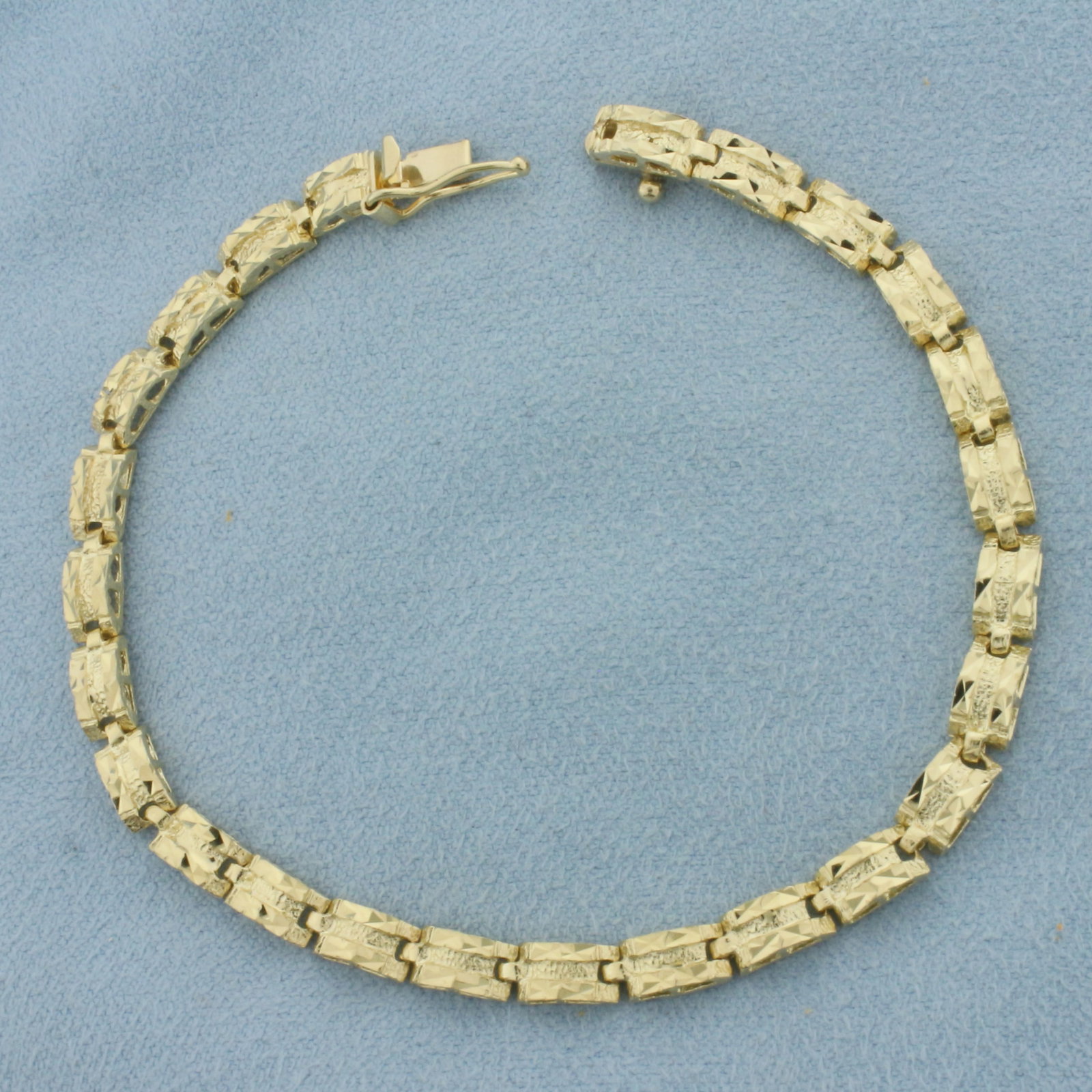 Diamond Cut Nugget Design Bracelet in 14k Yellow Gold: In 14k Yellow Gold. 7 1/4 inches long. 3.8mm wide. Concealed slide clasp with safety latch. 7.0g.