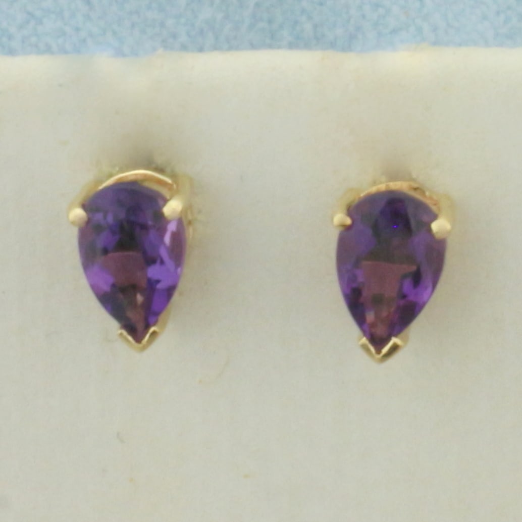 Pear Shaped Amethyst Stud Earrings in 14k Yellow Gold: In 14k Yellow Gold. Contains two 4x6mm high quality pear cut natural Amethyst gemstones, approximately 1ct TW, with intense color and excellent clarity. Friction backs. 1.0g.