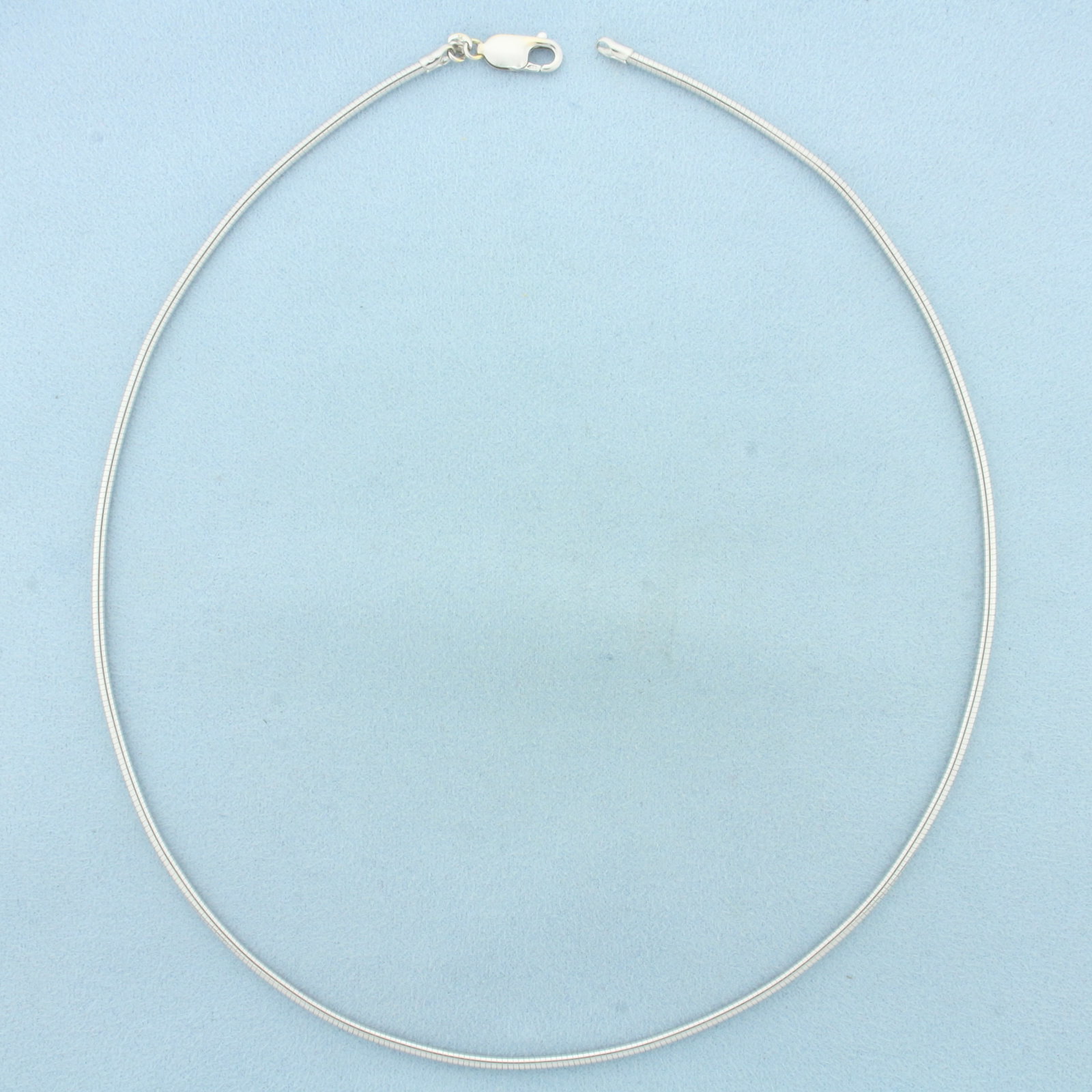 18 Inch Omega Link Necklace in 14k White Gold: In 14k White Gold. 18 inches long. 2mm wide. Lobster clasp. 15.0g.