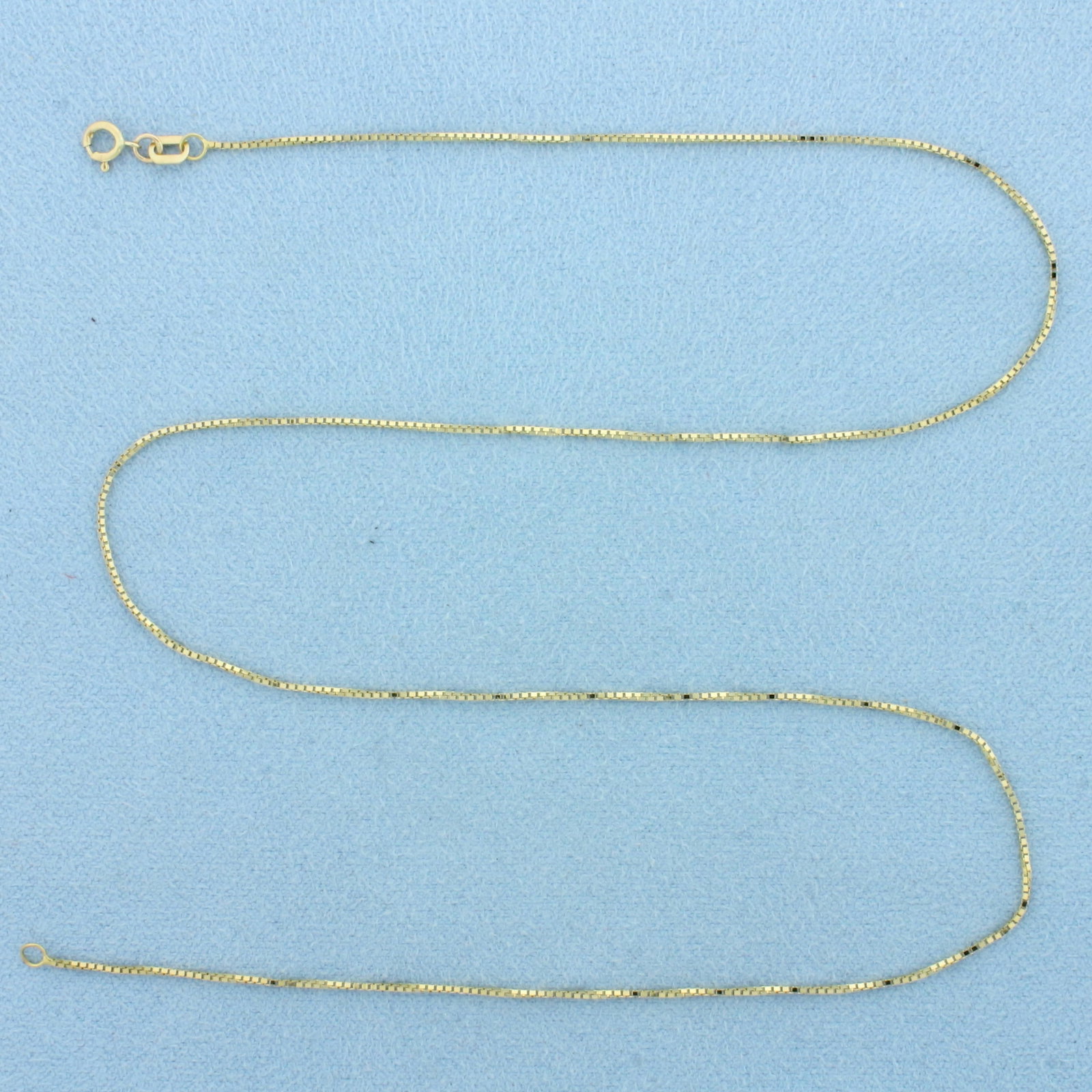 17 Inch Box Link Chain Necklace in 14k Yellow Gold: In 14k Yellow Gold. 17 inches long. 0.8mm wide. Spring clasp. 1.4g.