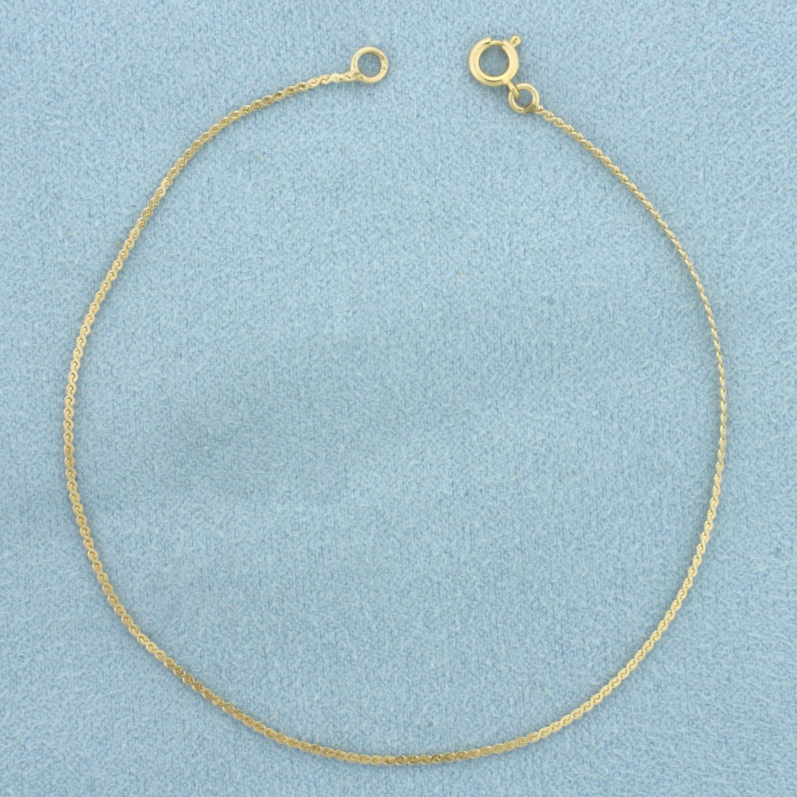 S-Link Serpentine Bracelet in 14k Yellow Gold: In 14k Yellow Gold. 7 1/8 inches long. 1.0mm wide. Spring clasp. .7g.