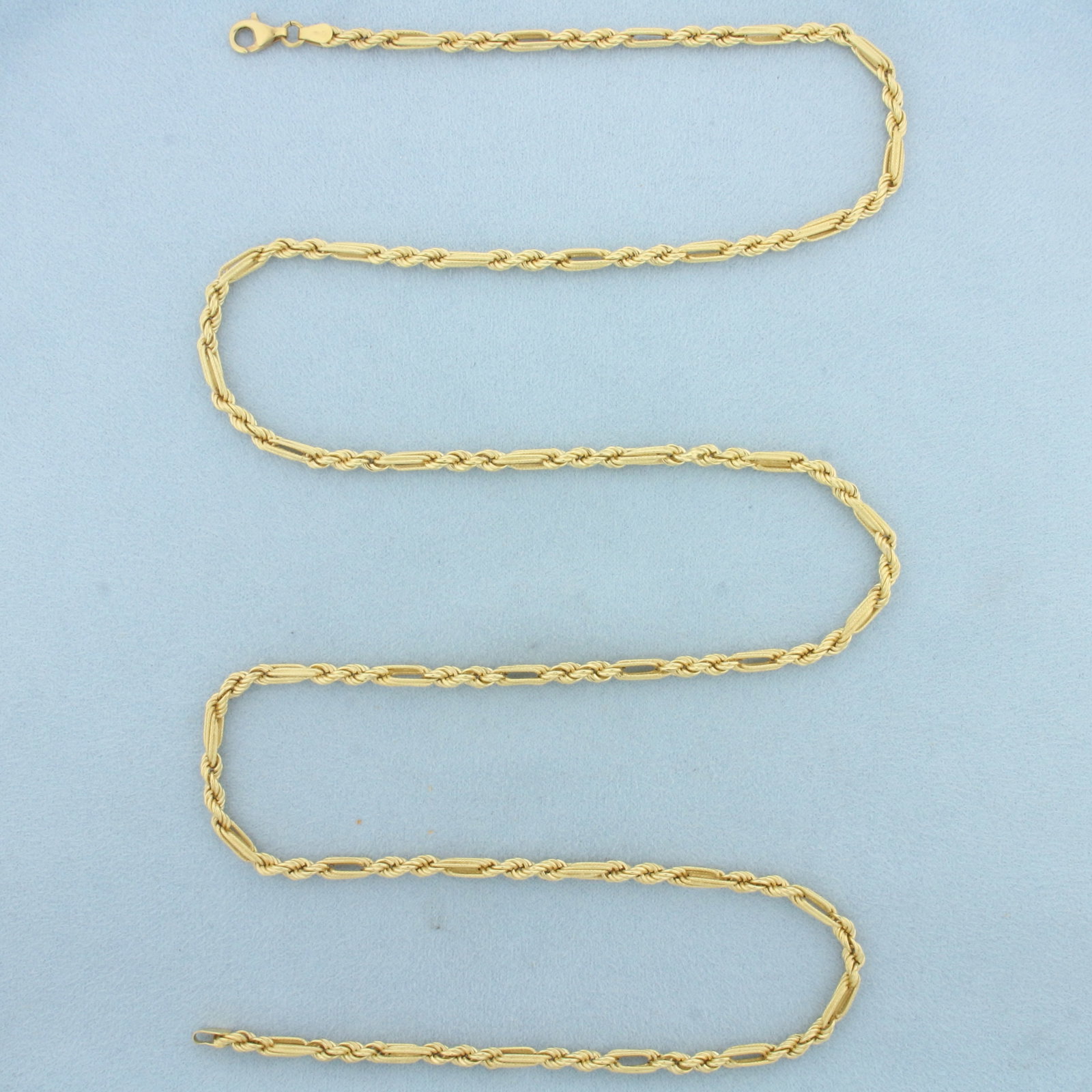 32 Inch Rope Figaro Link Chain Necklace in 18k Yellow Gold: In 18k Yellow Gold. 32 inches long. 3.2mm wide. Lobster clasp. 15.9g.