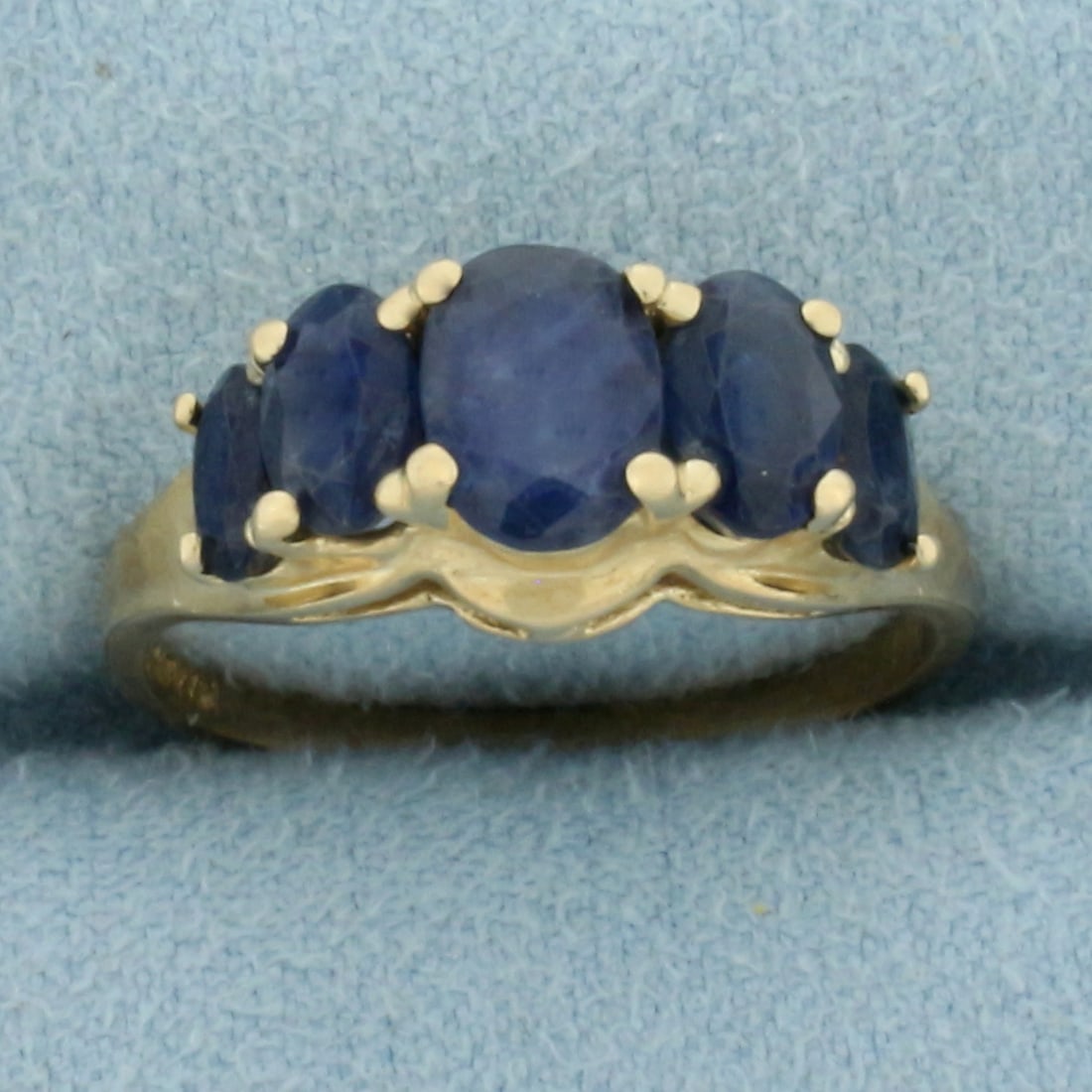 Vintage Natural Sapphire Ring in 14k Yellow Gold: In 14k Yellow Gold. Contains 5 oval cut high quality natural sapphire gemstones, one 1ct, two .6ct, and two .4ct, all with deep royal blue color. 3ct total weight. Approx. 8.3mm wide at top of ring. S