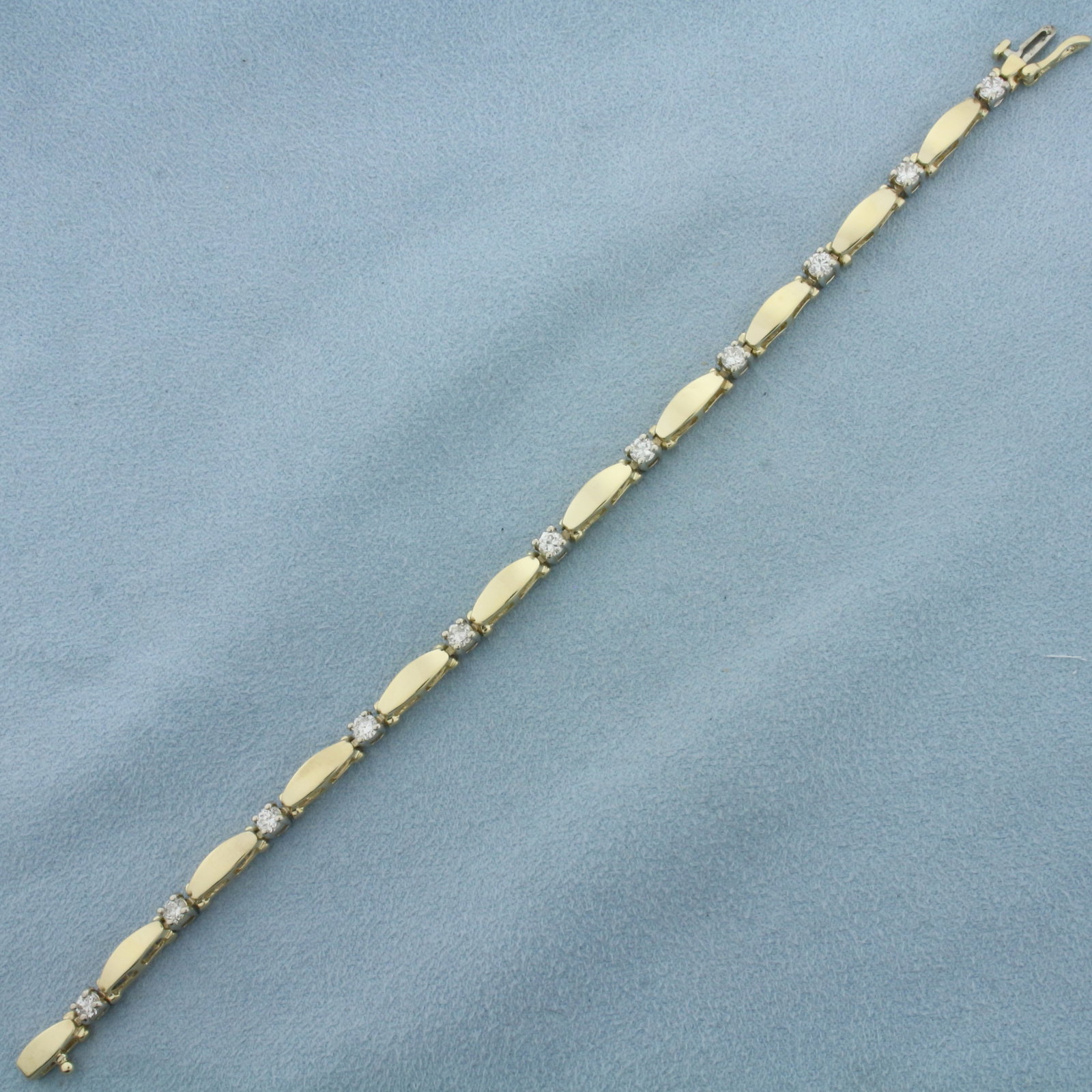 Diamond Bracelet in 14k Yellow Gold: In 14k Yellow Gold. Contains eleven high quality diamonds, 1.5ct TW, VS clarity/H color. 7 1/4 inches long. 4.1mm wide. Concealed slide clasp with safety latch. 12.6g.